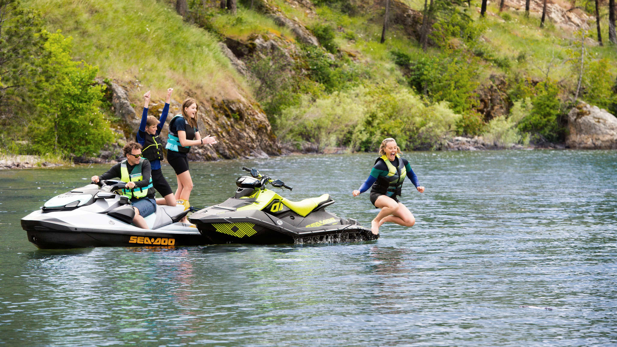 Woman jumping off her SPARK TRIXX with the family cheering on GTI SE