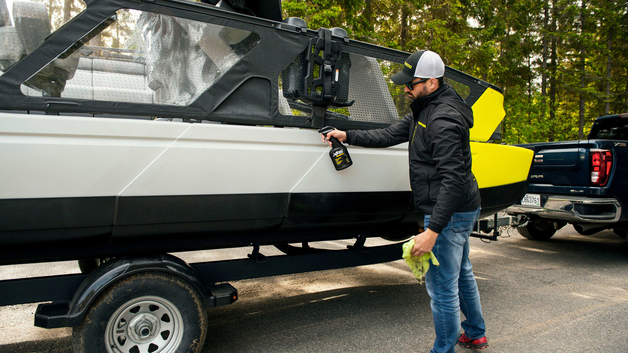 Man cleaning his Sea-Doo Switch with XPS products