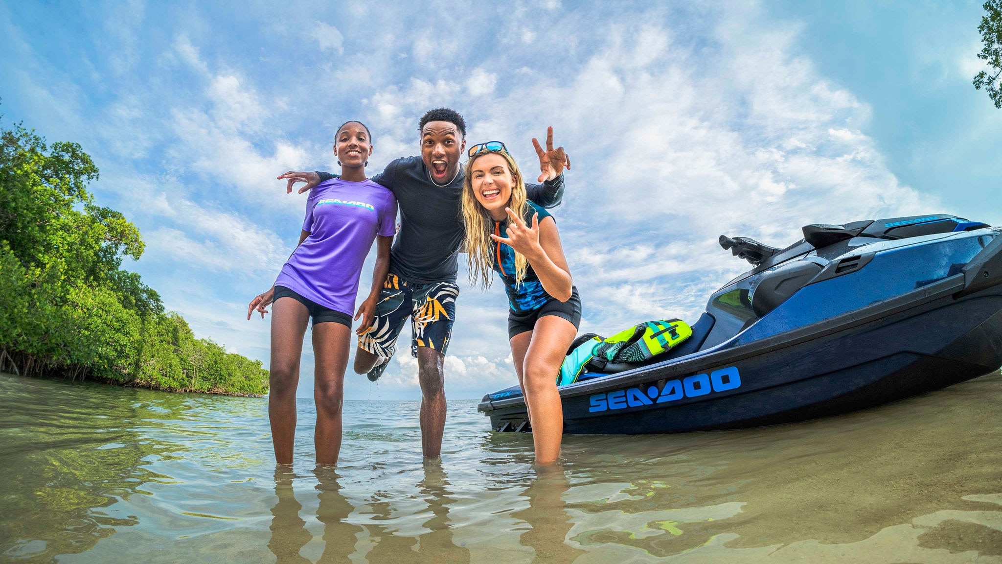 Three friends posing in Sea-Doo apparel	