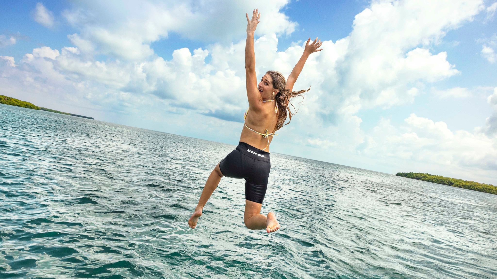 Woman jumping into the water