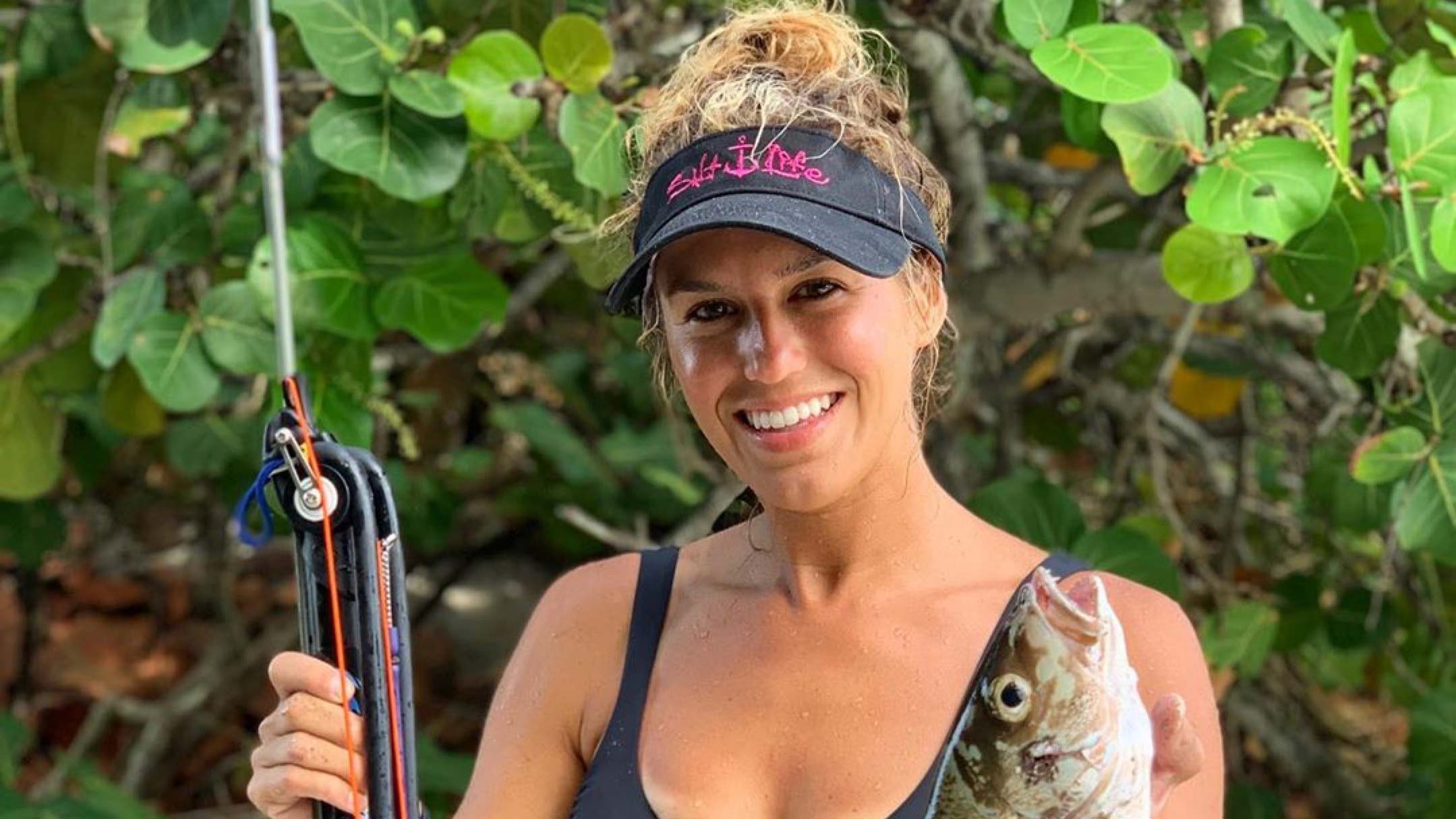 Bri Andrassy posing with a fish