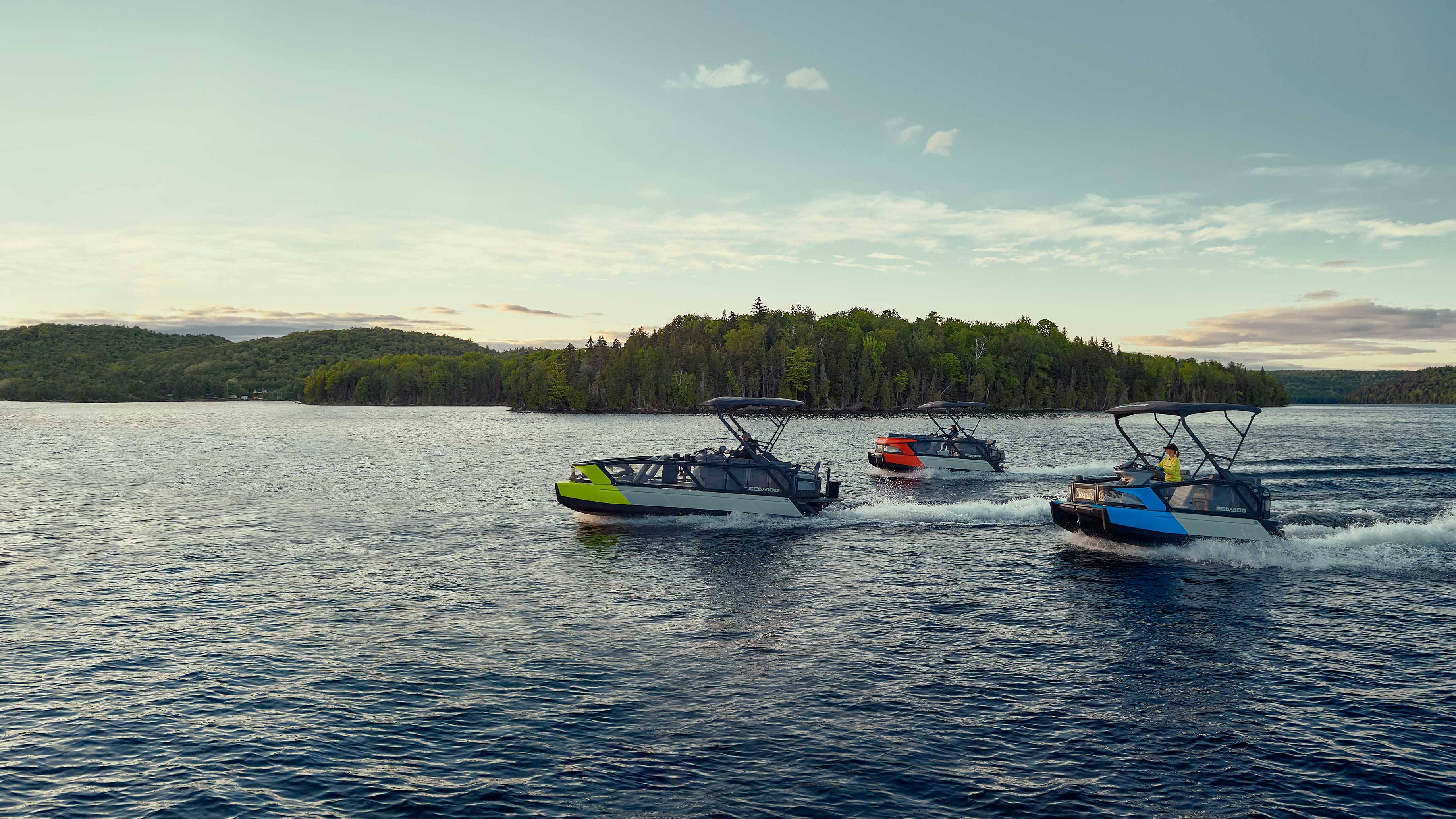 Three Sea-Doo Switch Cruise pontoon boats on a lake