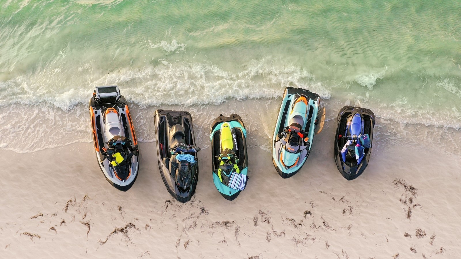 Multiple Sea-Doo watercraft on a beach