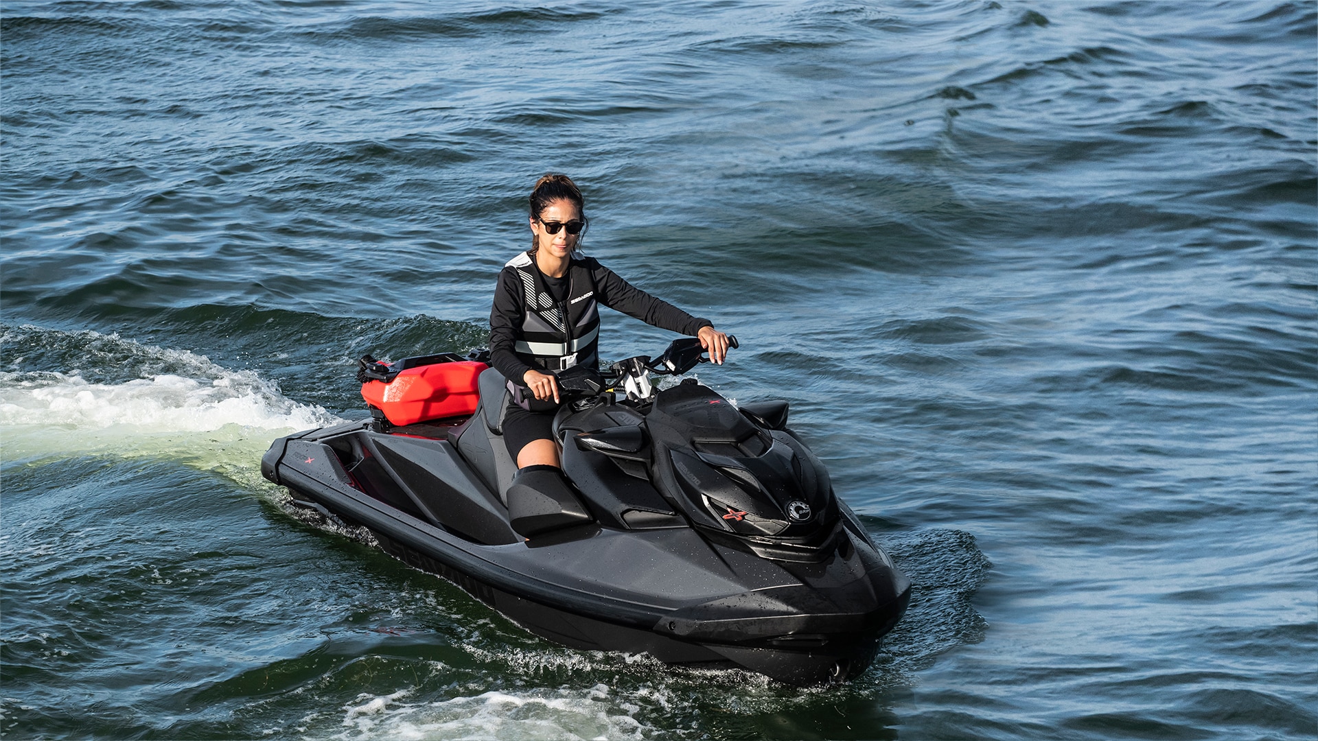 Woman casually riding a Sea-Doo RXP-X personal watercraft