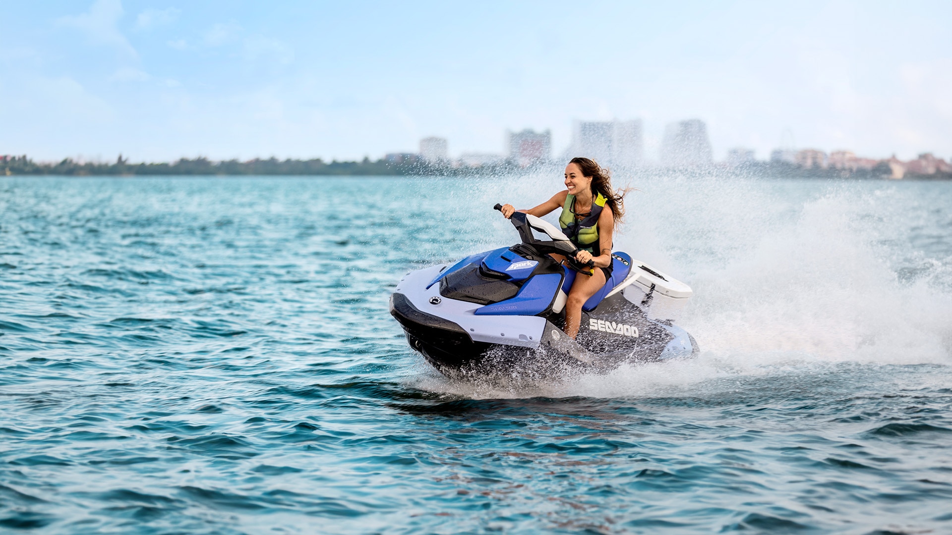 Rider zooming across the water on her Sea-Doo PWC