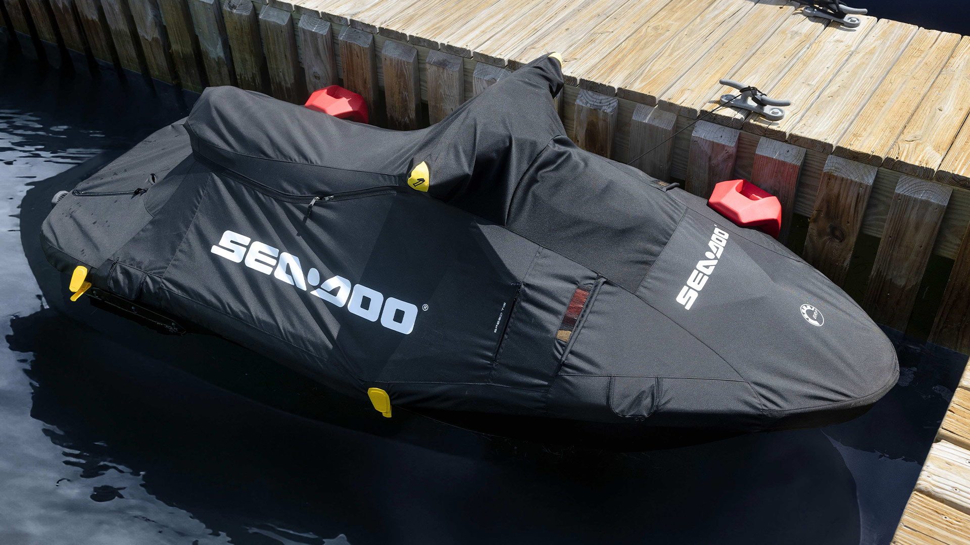 Personal watercraft protected by a Sea-Doo cover at the dock