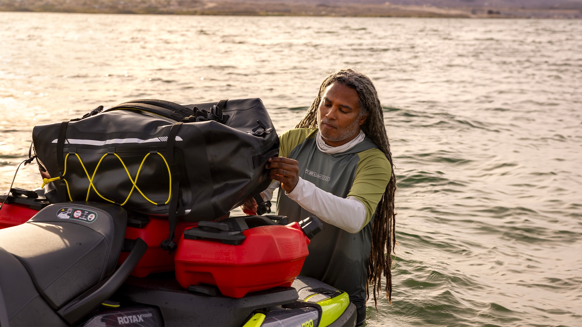 Man securing a bag on his Sea-Doo with LinQ accessories