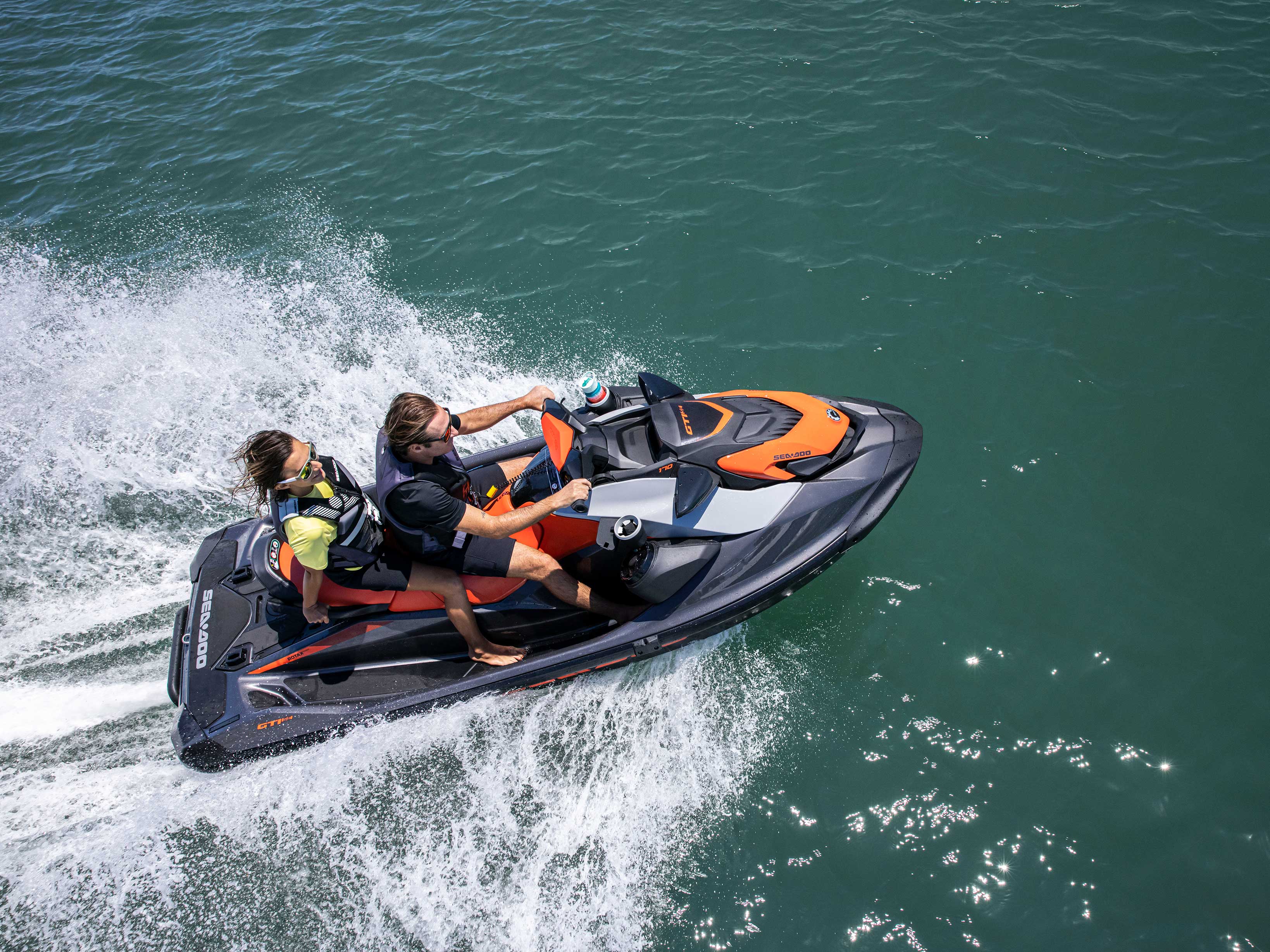 Couple riding a Sea-Doo GTI personal watercraft