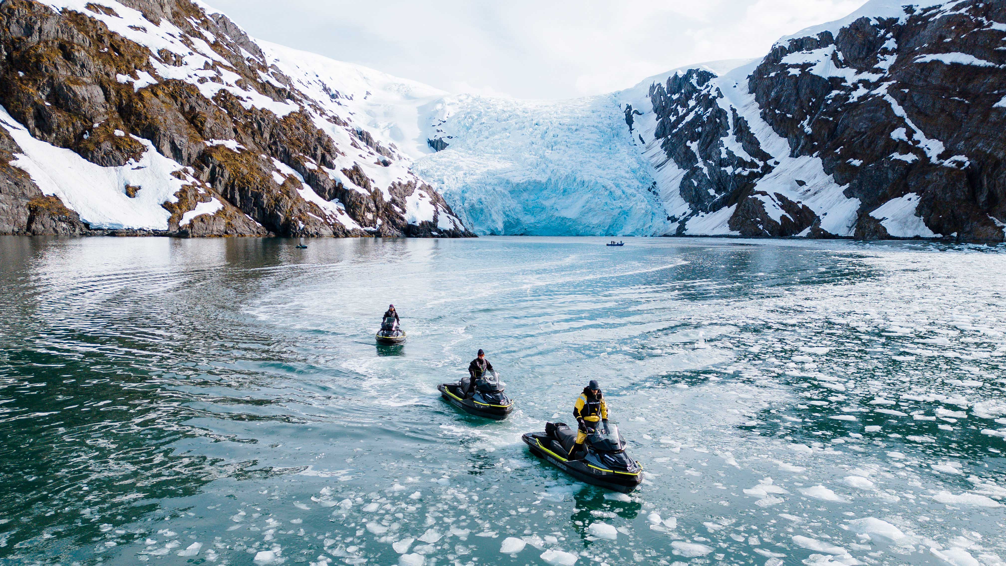 Three personal watercraft enthusiasts riding their Sea-Doo in Alaska