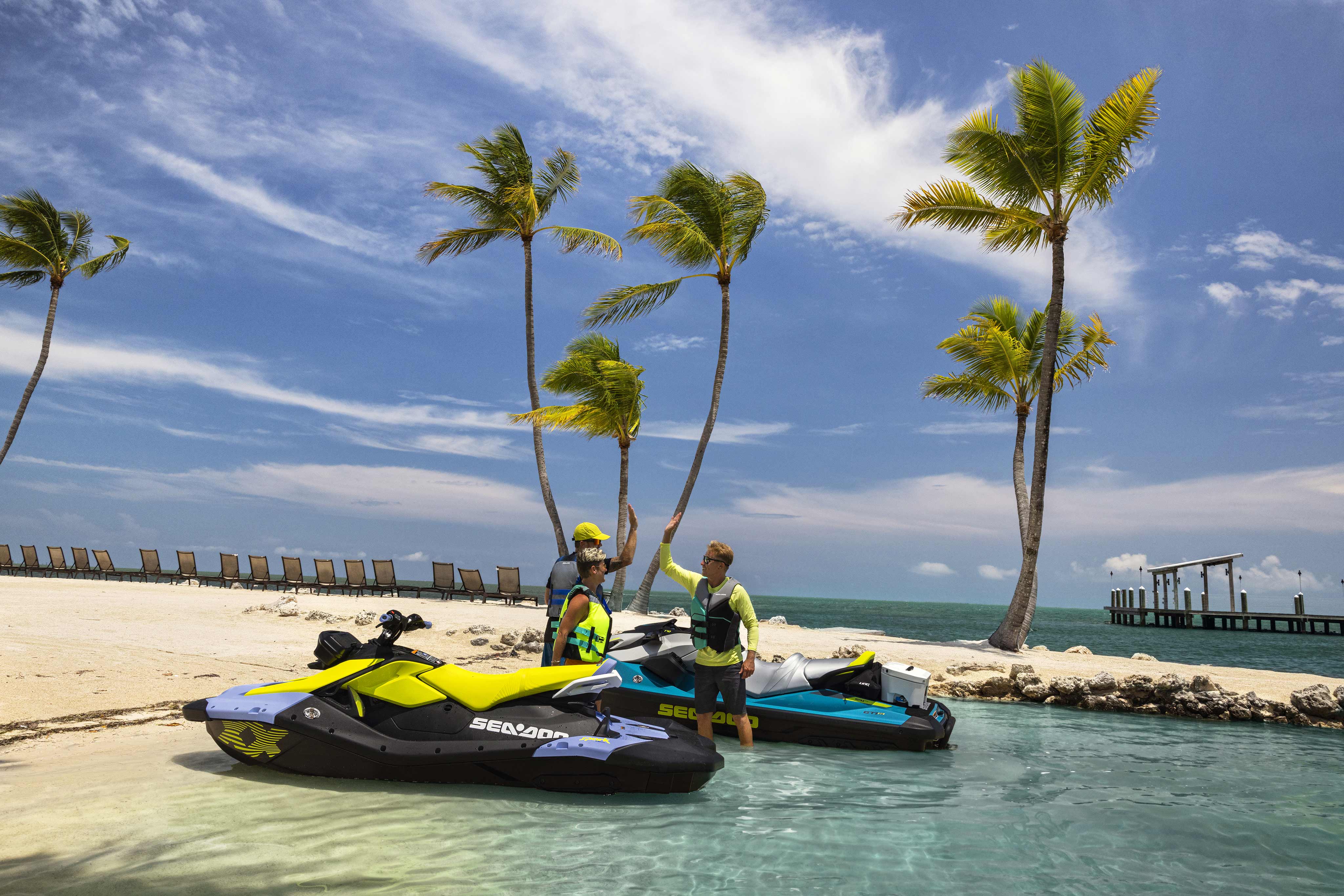 Friends enjoying the beach with the 2024 Sea-Doo Spark personal watercraft lineup