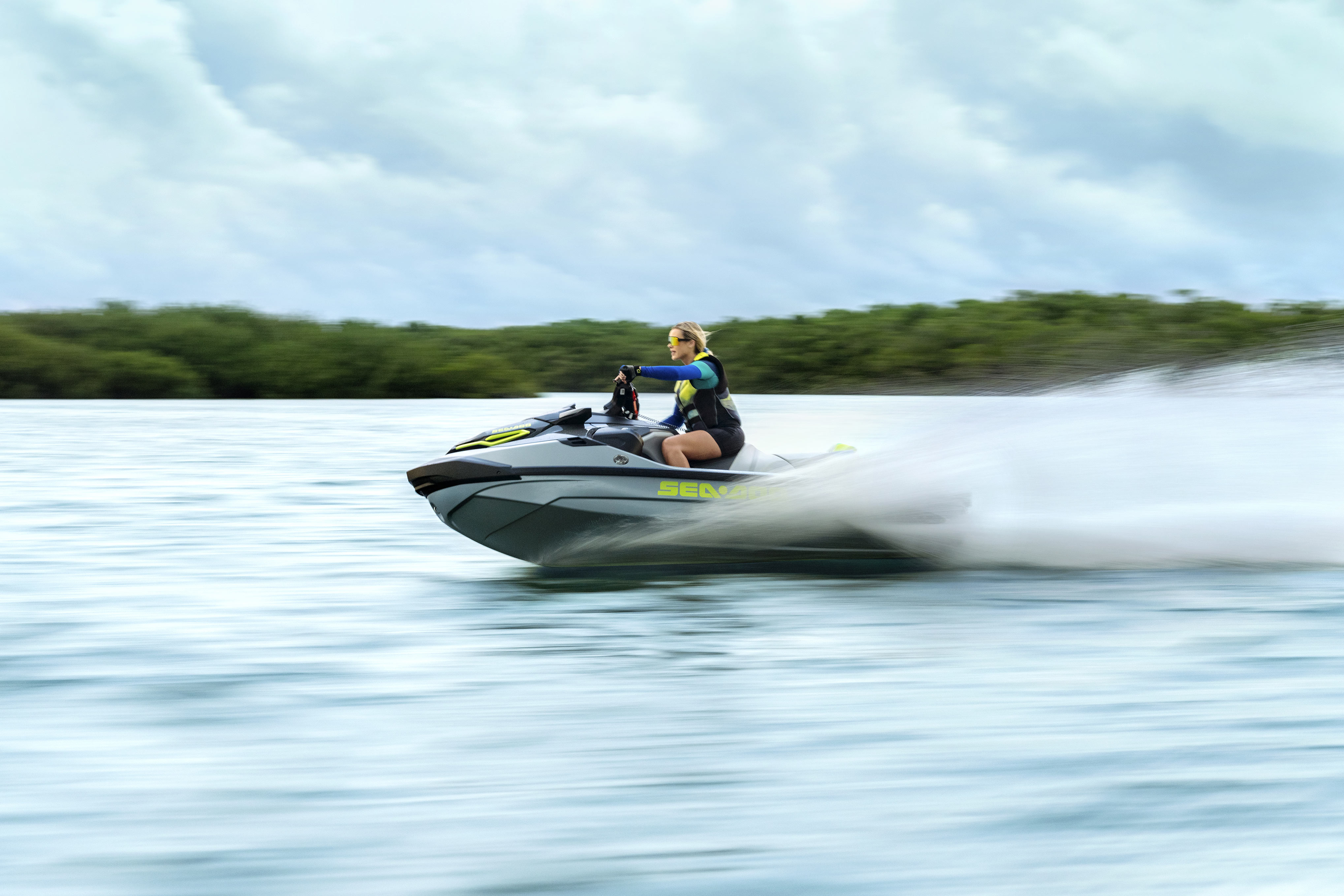 Woman riding a Sea-Doo RXT-X 325 at high speeds