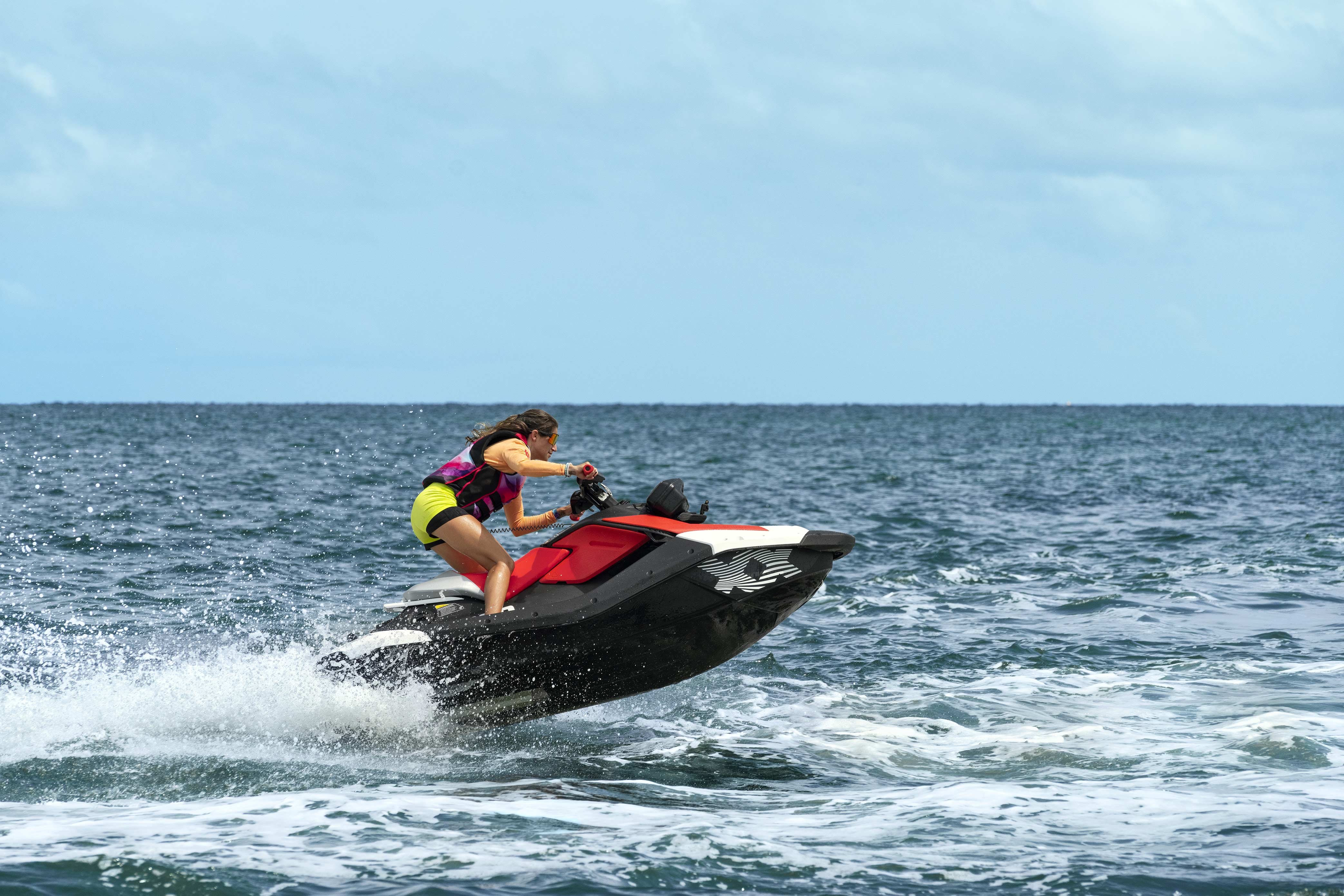 Femme qui conduit une motomarine Sea-Doo Spark Trixx