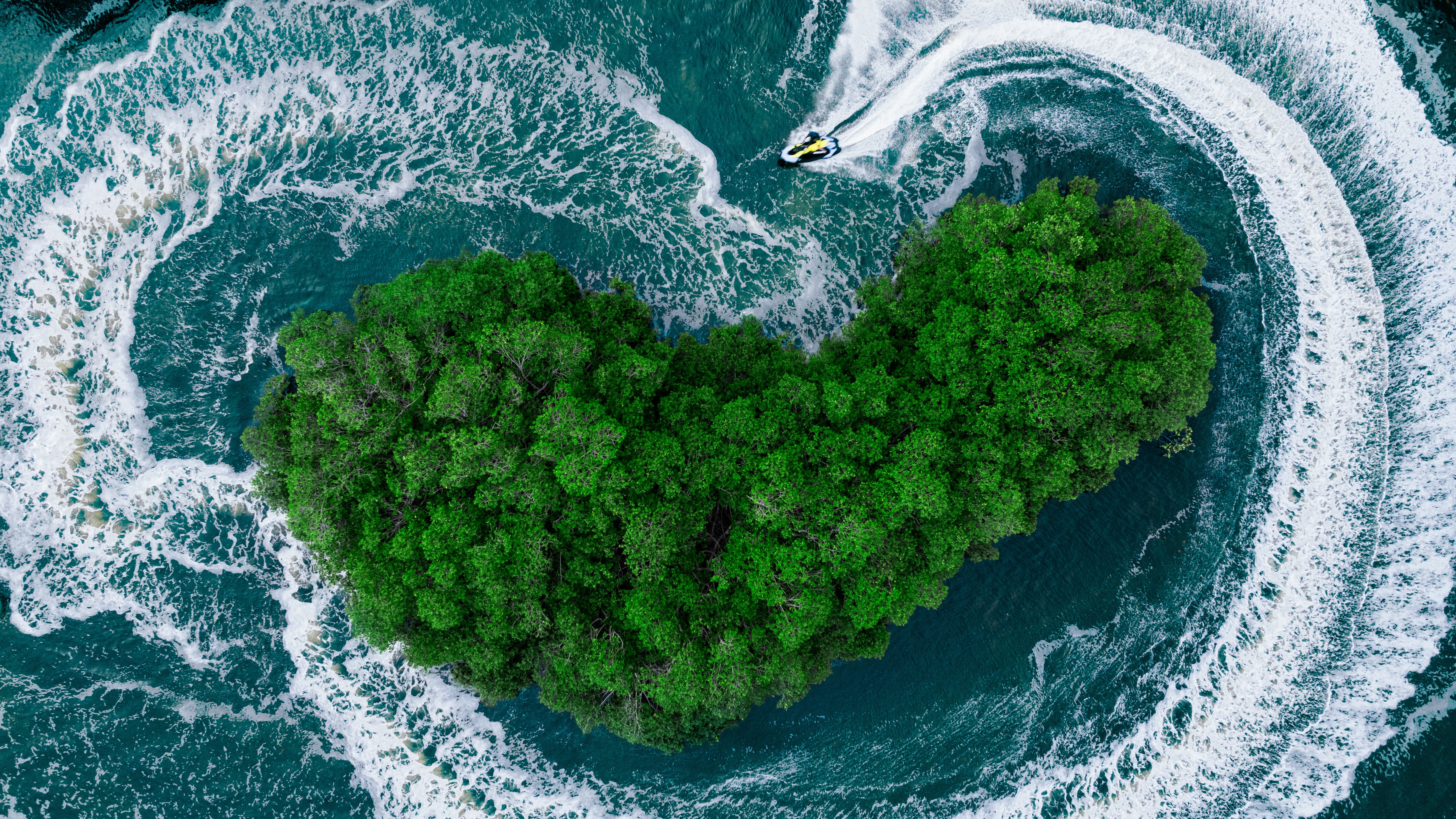 Person riding a Sea-Doo Spark Trixx personal watercraft around an island of trees