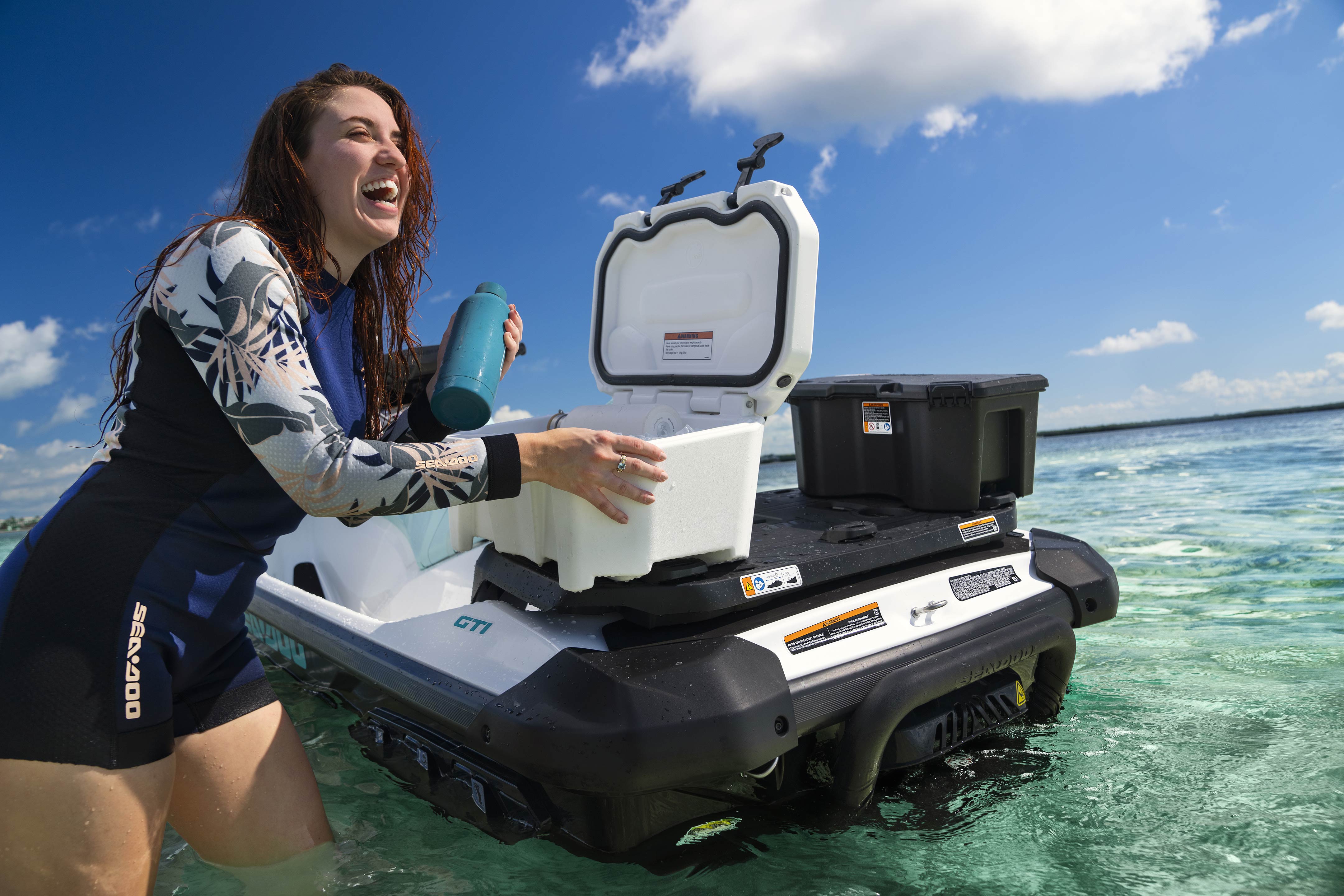 Woman using a cooler on her Sea-Doo GTR personal watercraft