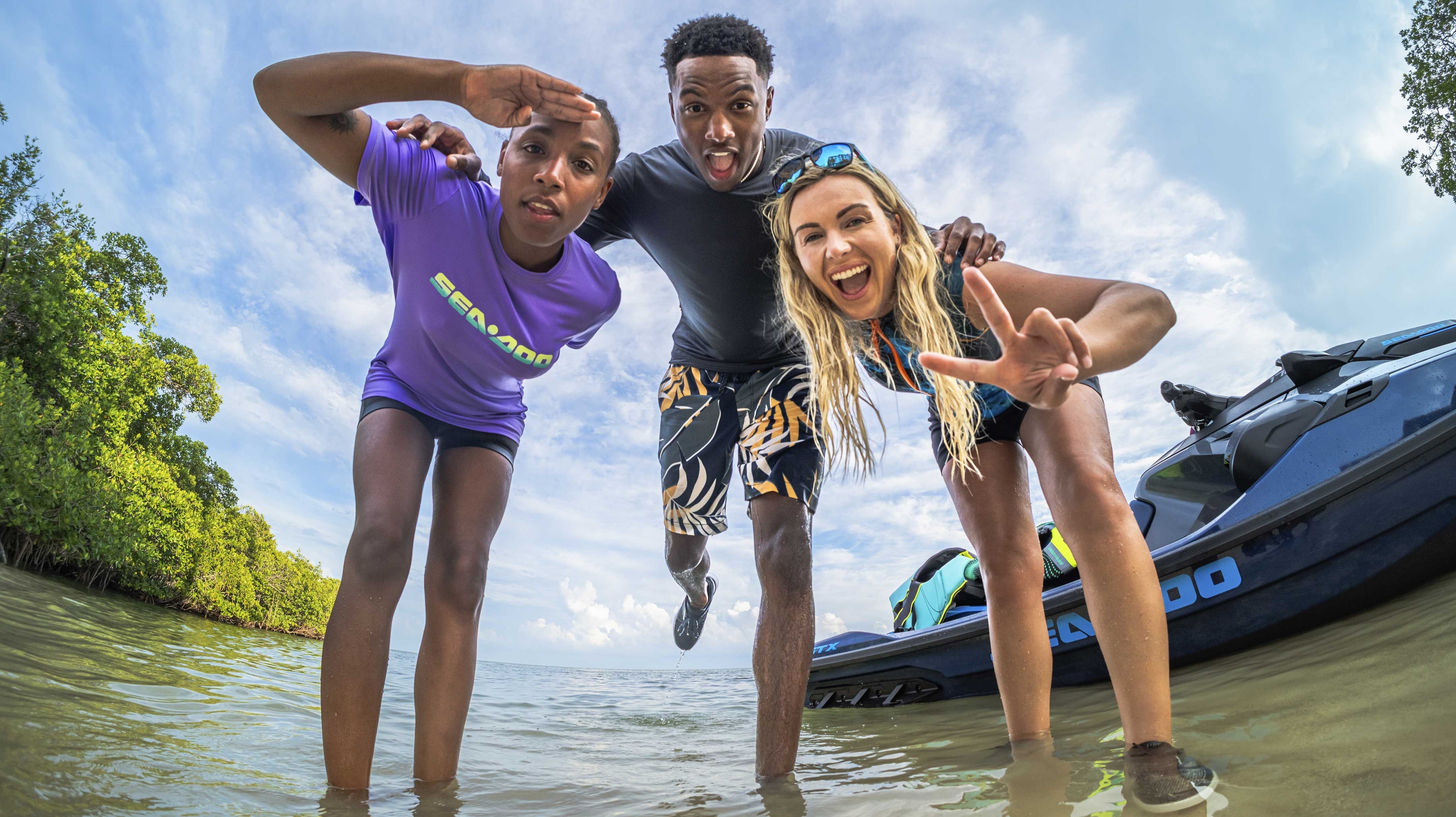 3 friends wearing Sea-Doo gear playing in the water