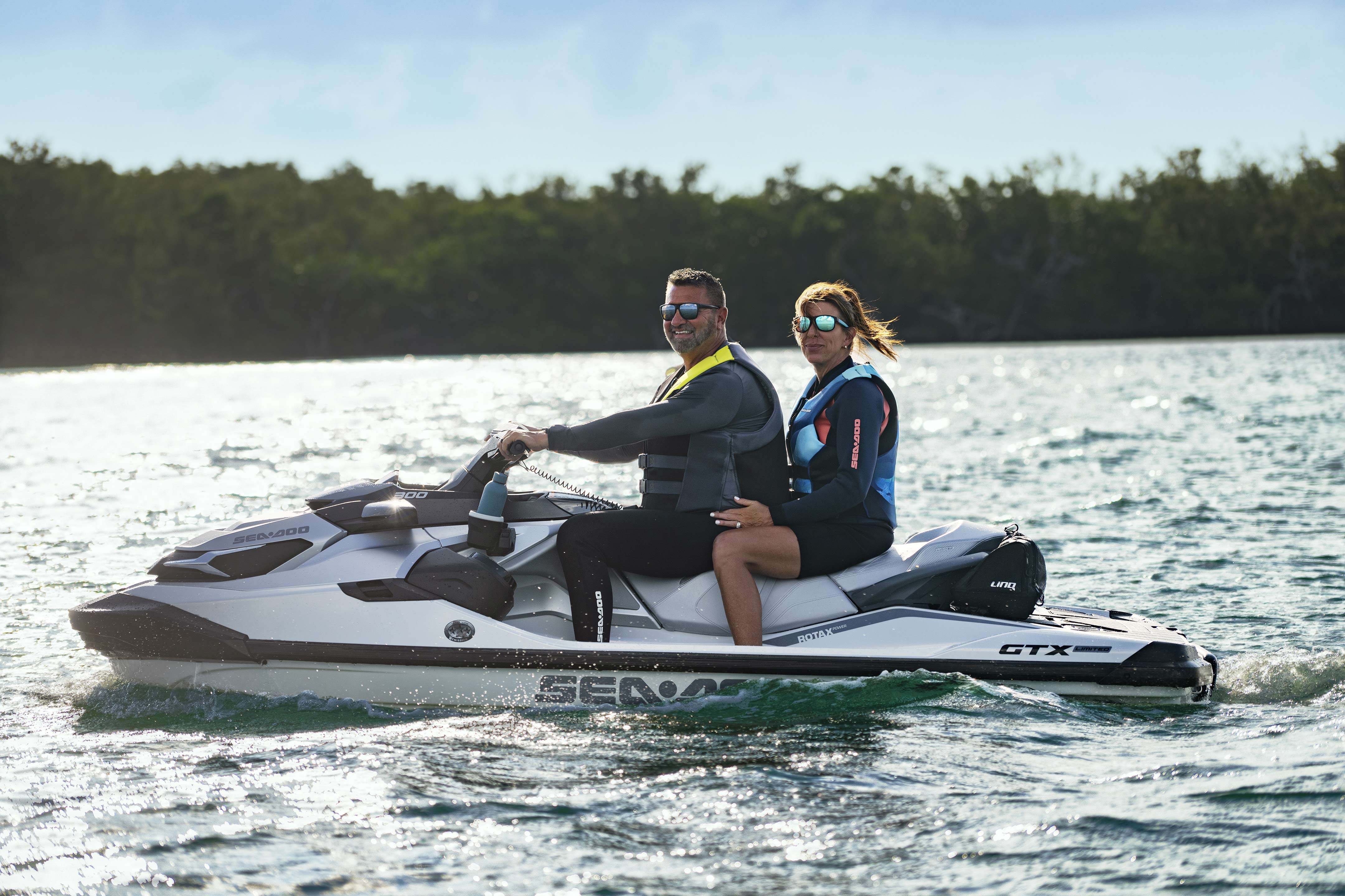 Man and woman sitting on a Sea-Doo GTX Limited personal watercraft