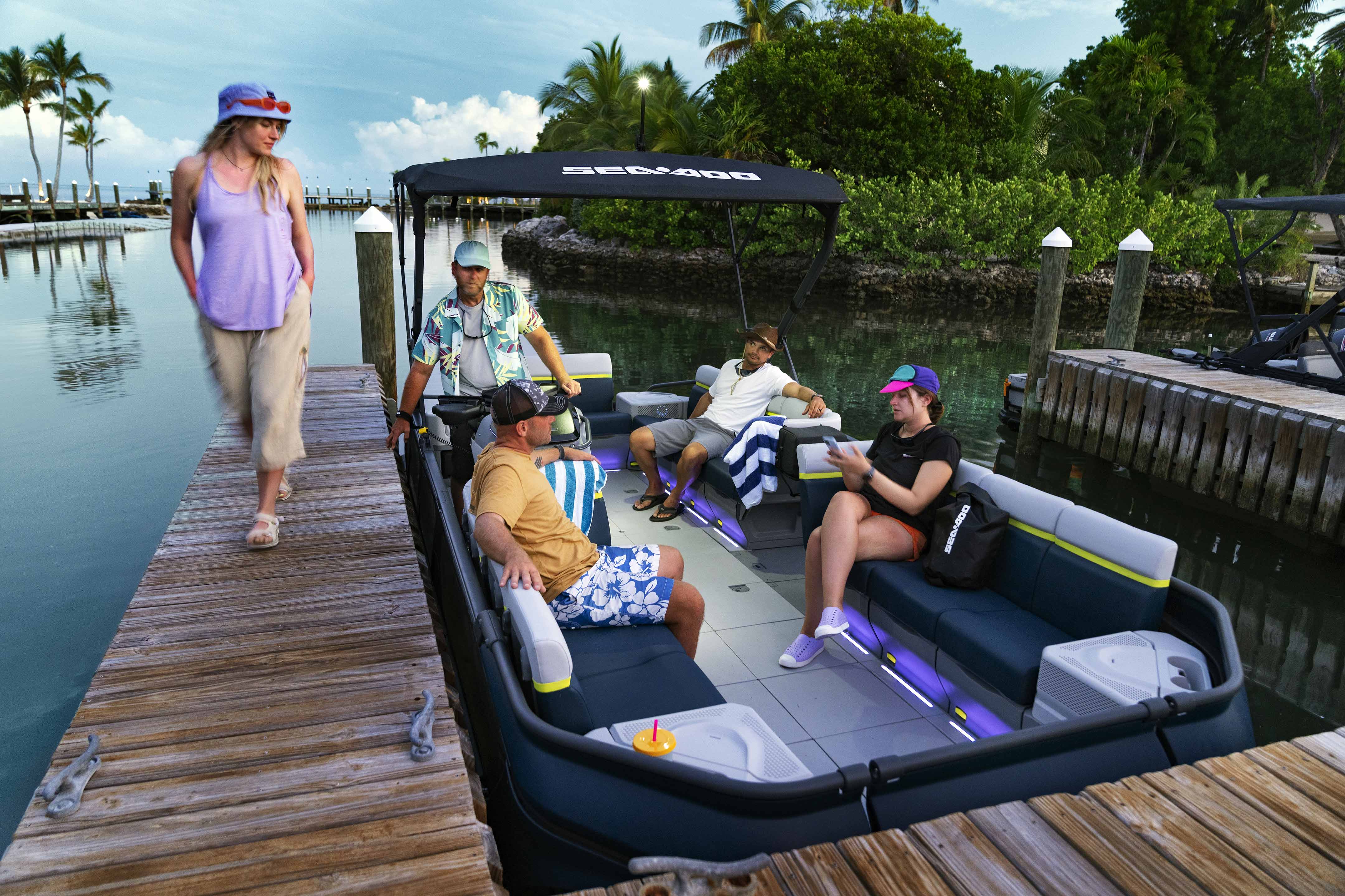 Friends hanging out in a docked Sea-Doo Switch Cruise Limited pontoon
