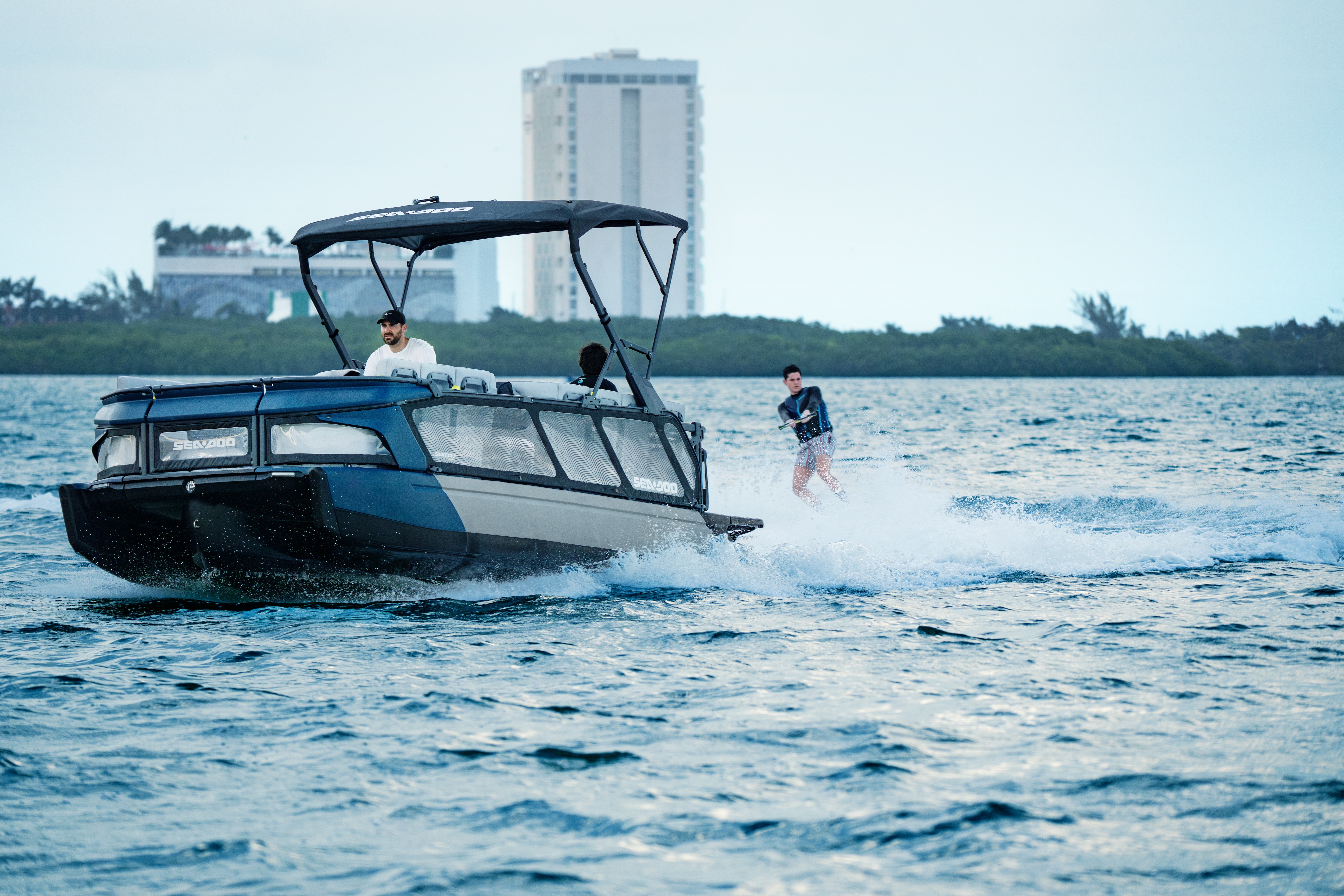 Sea-Doo Switch Limited pontoon boat pulling a wakeboarder