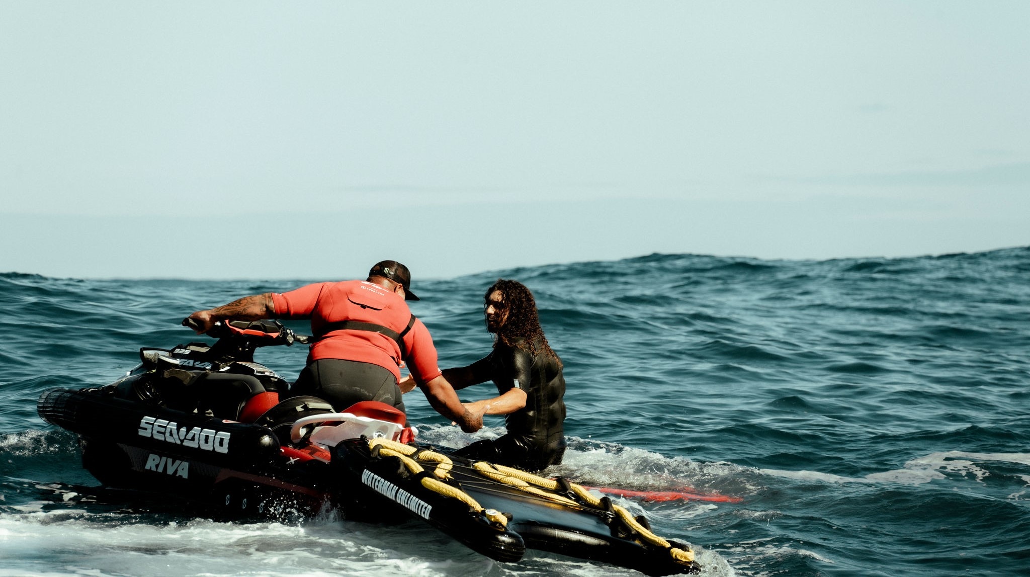 Kurtis Chong Kee helping a surfer on his Sea-Doo PWC