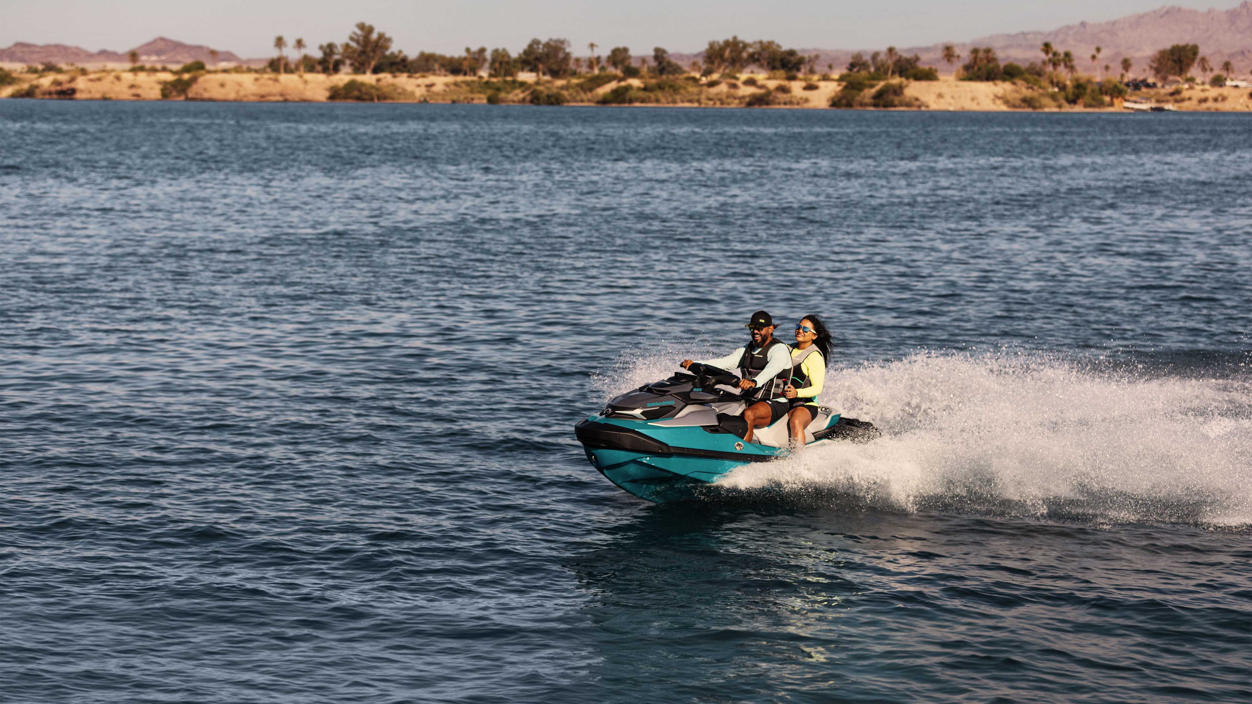 A couple riding the 2025 Sea-Doo GTX Limited personal watercraft