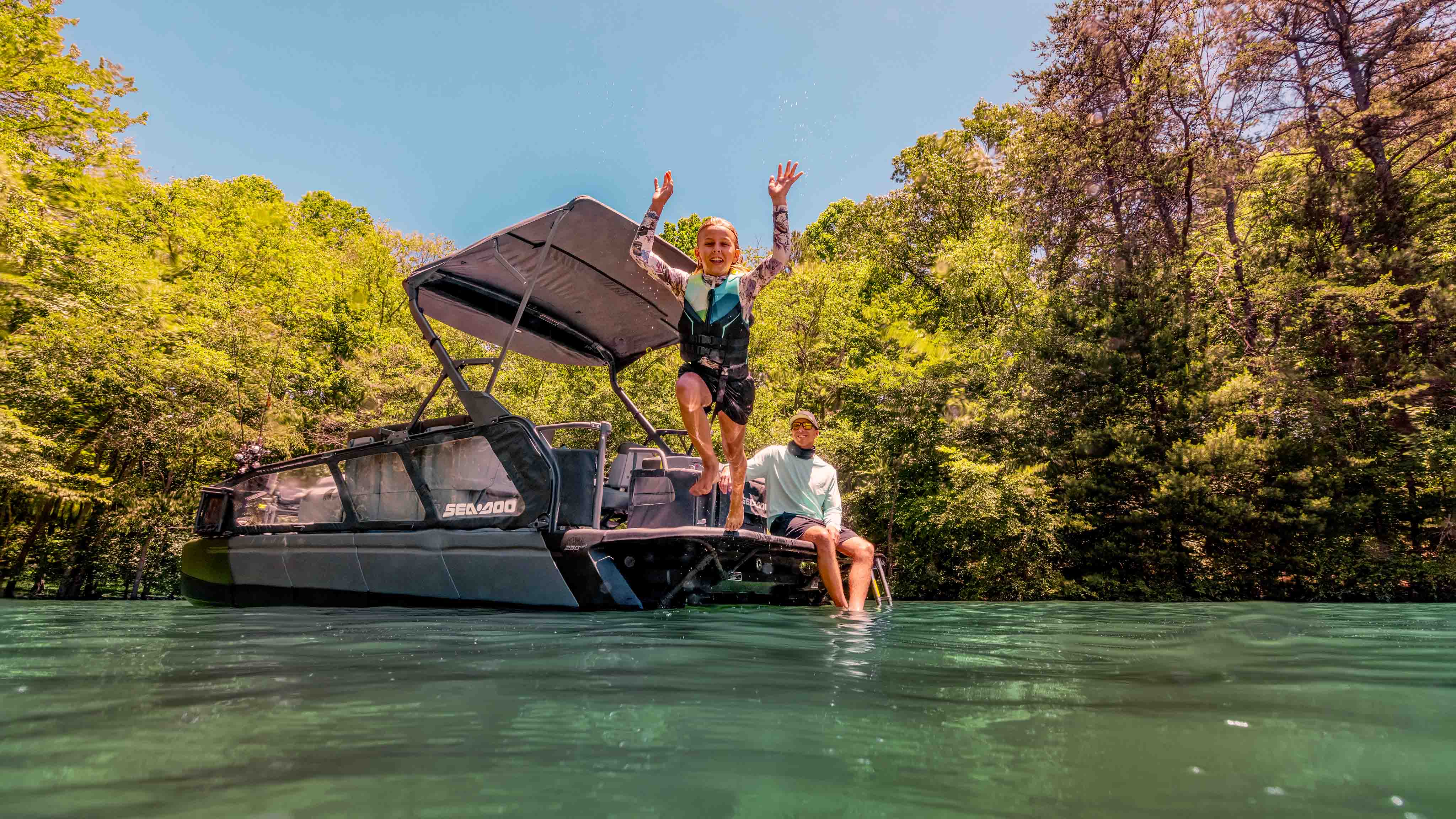 Father and daughter having fun on the 2025 Sea-Doo Switch Fish pontoon boat