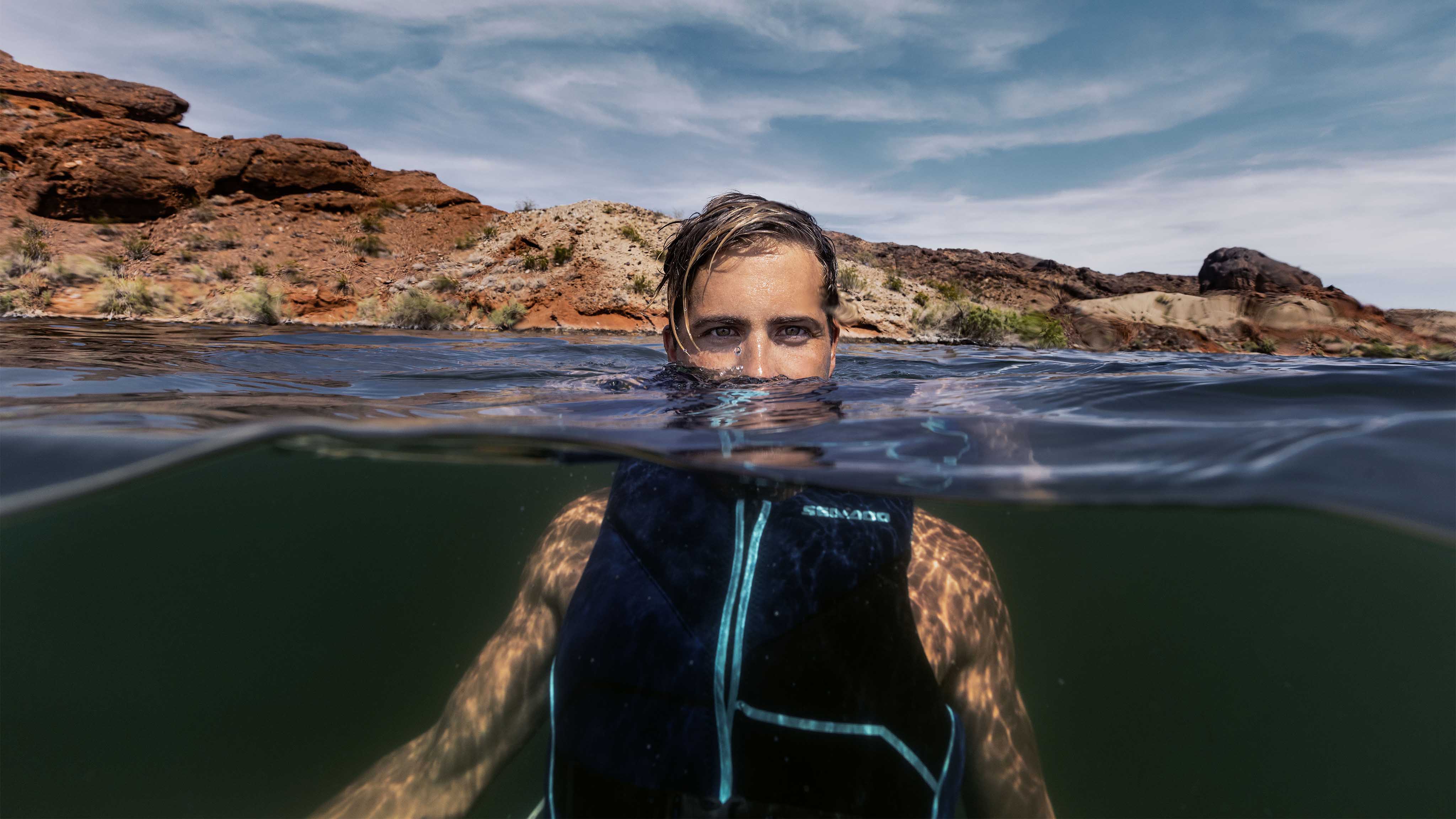 Outdoor enthusiast wearing a Sea-Doo branded personal flotation device (PFD)