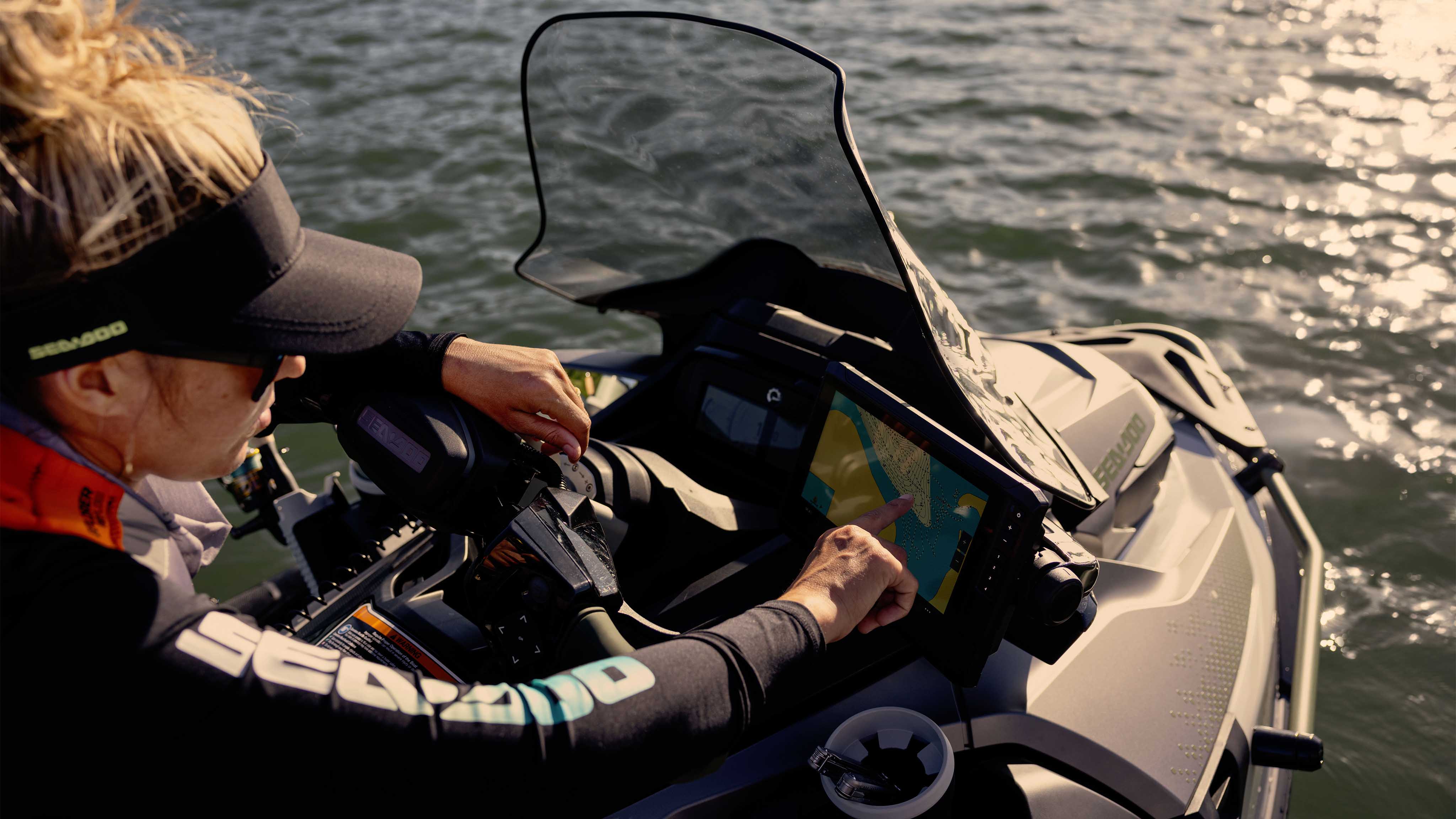 Woman using the 9-inch Garmin Fish Finder on the 2025 Sea-Doo FishPro Apex personal watercraft