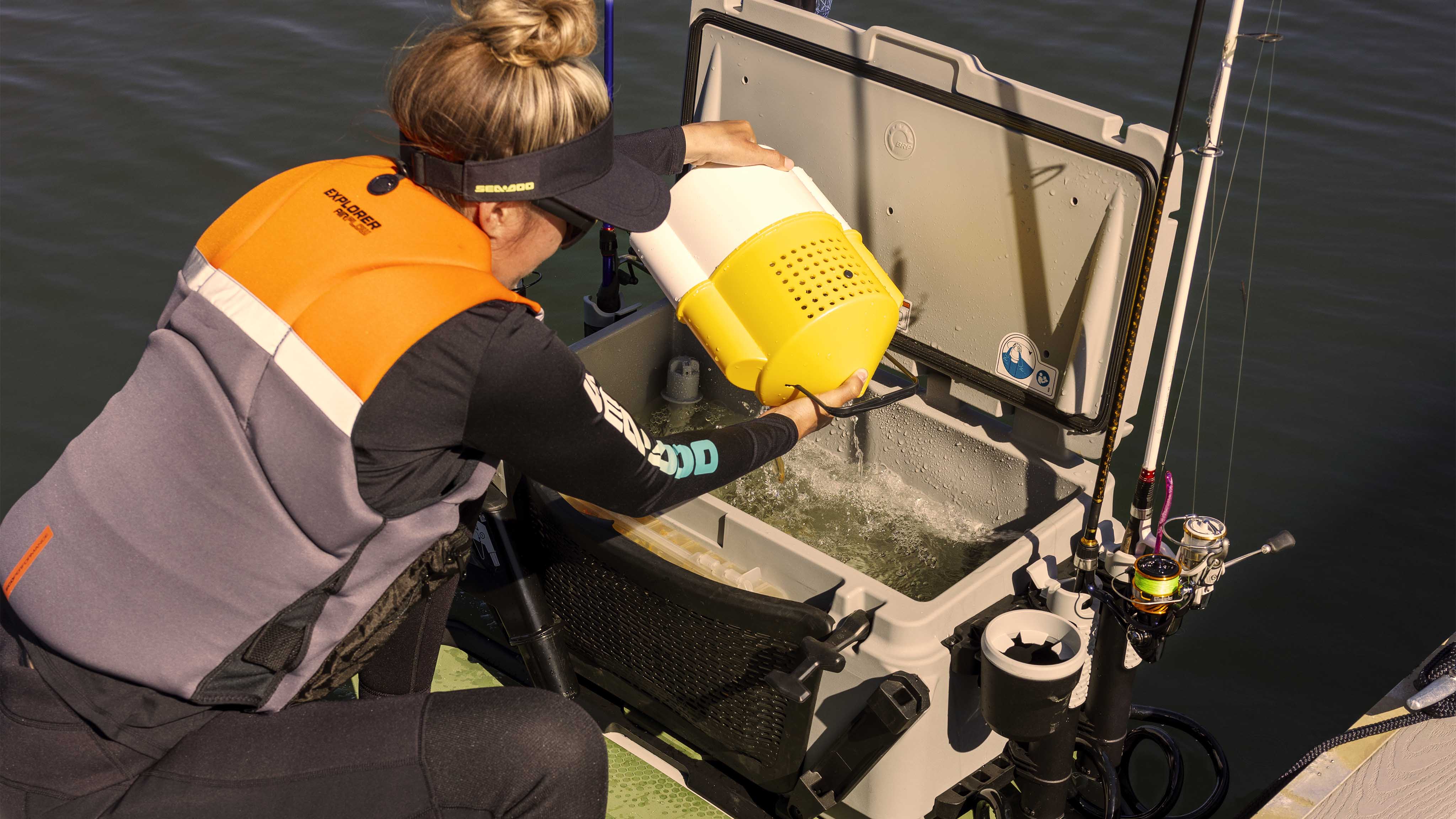 Woman using the livewell on the 2025 Sea-Doo FishPro Apex personal watercraft