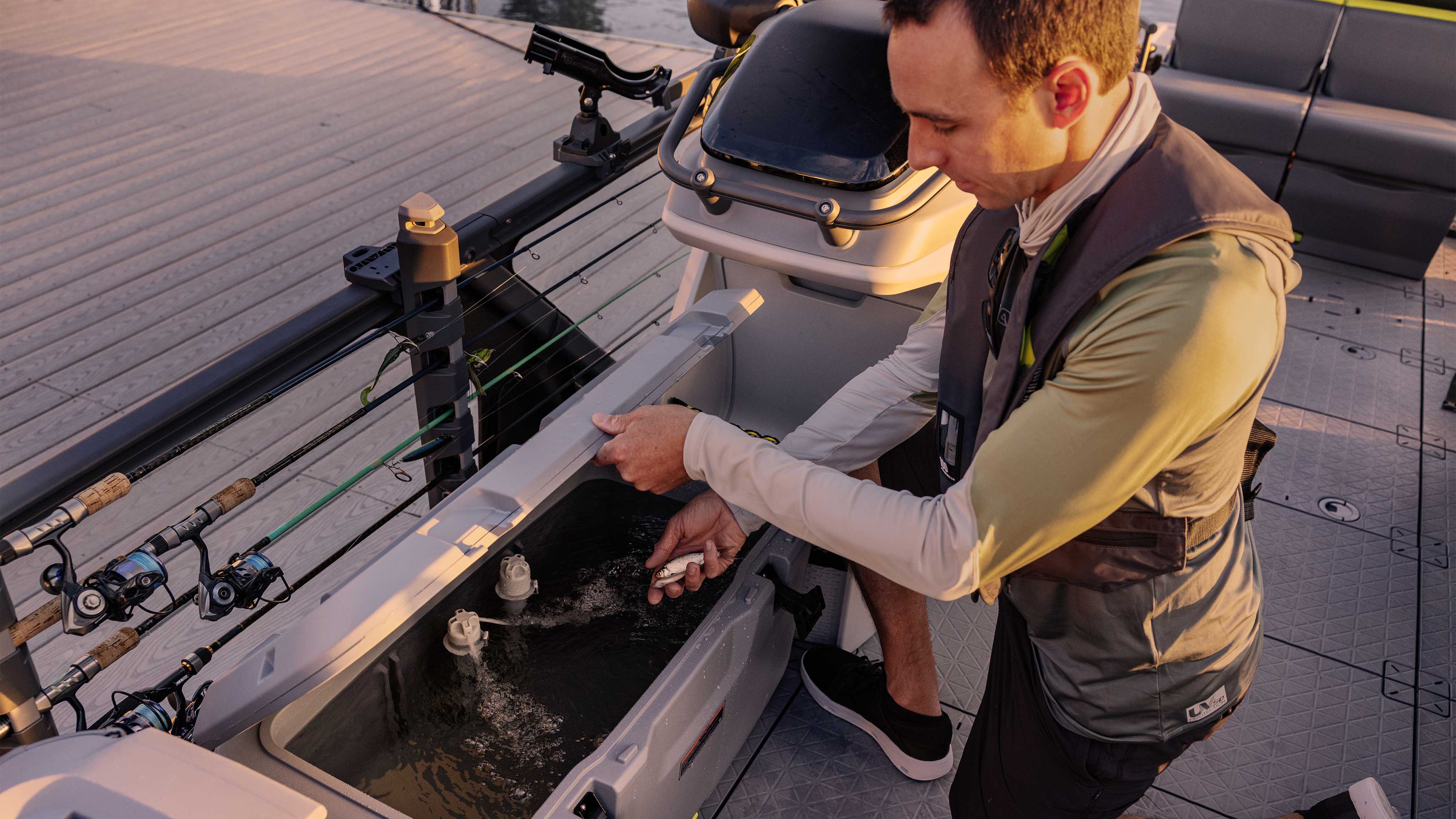 Fisherman using the livewell on the 2025 Sea-Doo Switch Fish pontoon boat