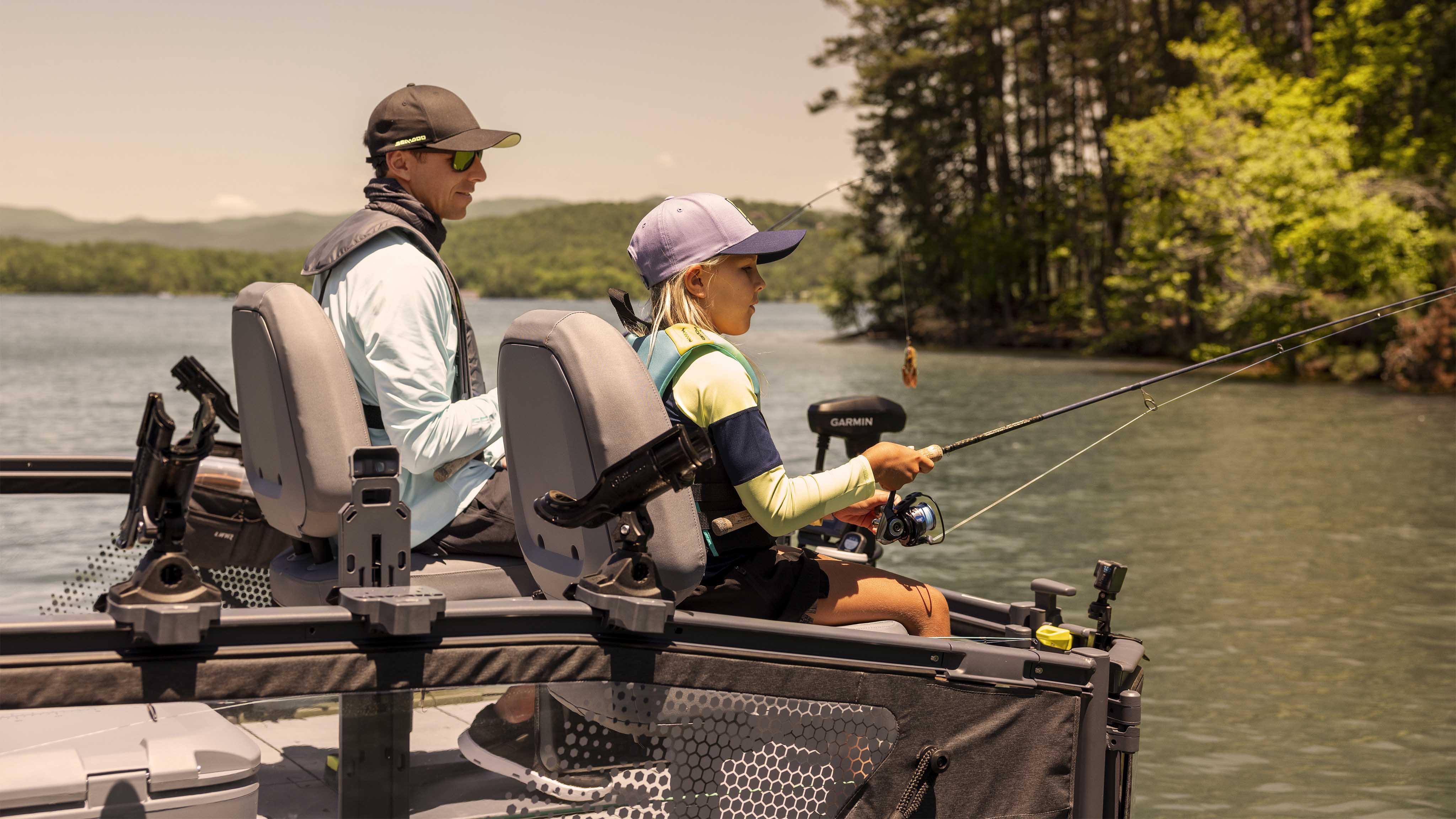 Father and daughter fishing from the 2025 Sea-Doo Switch Fish pontoon boat