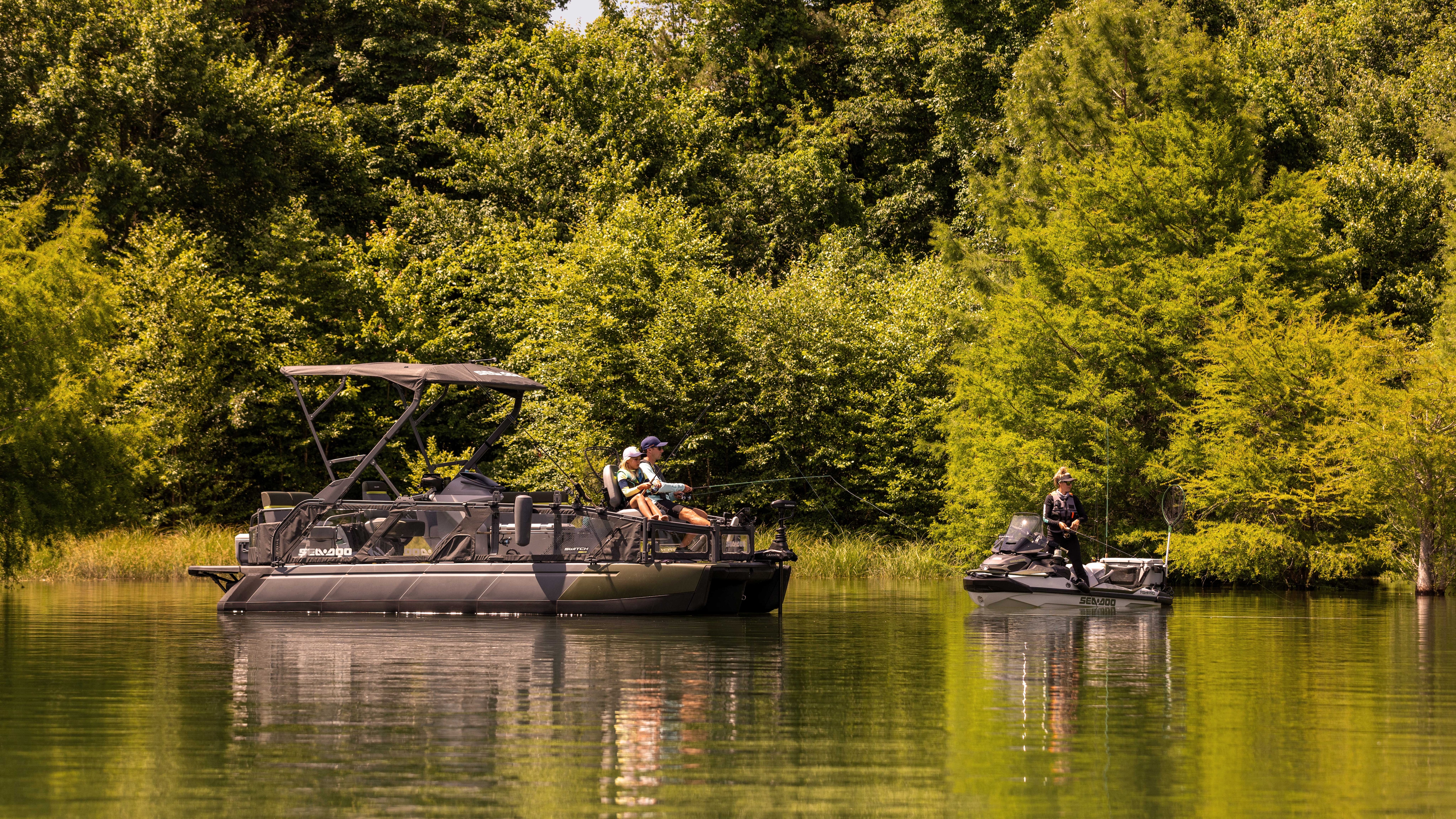 Father and daughter fishing from the 2025 Sea-Doo pontoon boat next to a woman fishing from the 2025 Sea-Doo personal watercraft