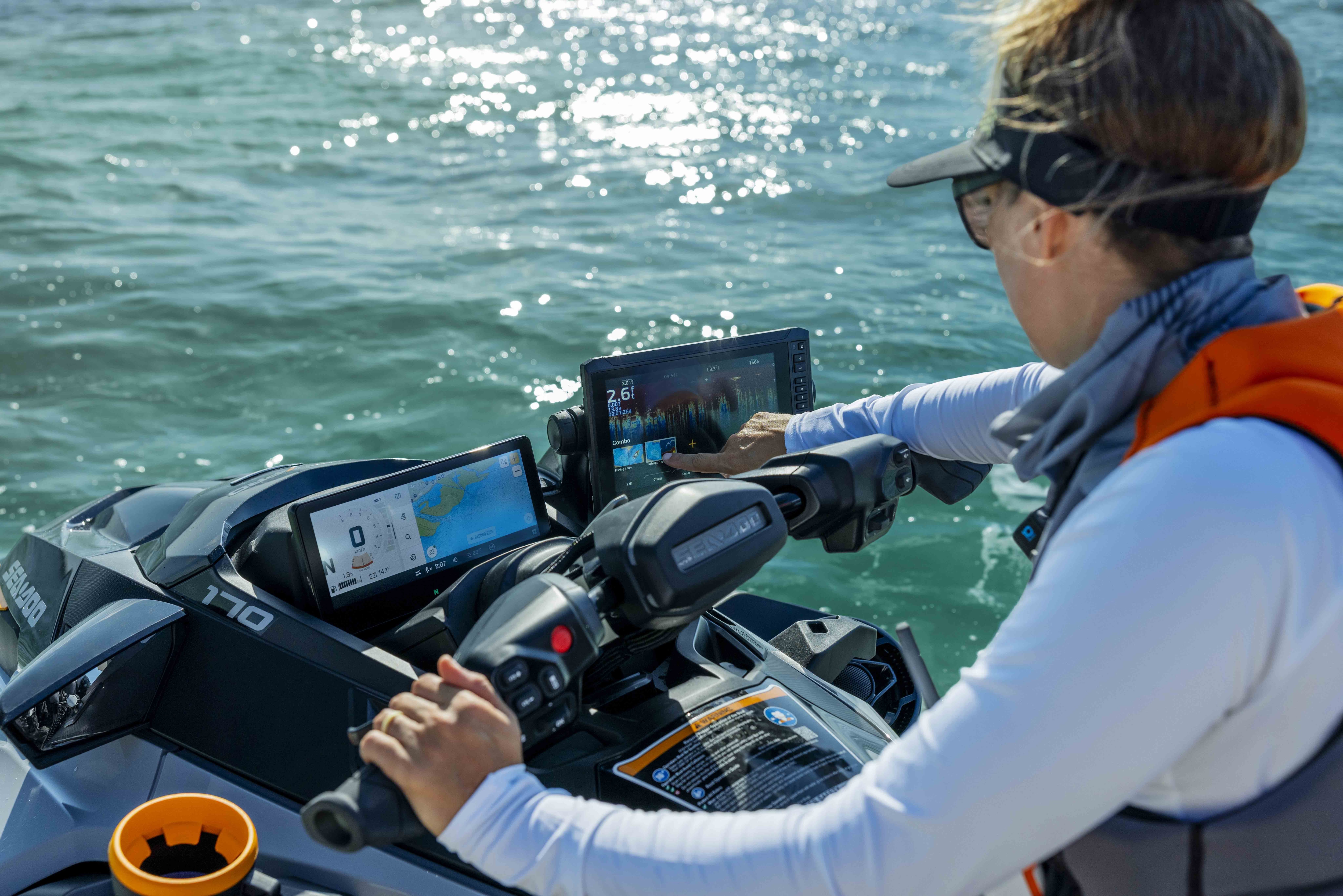 A woman using nautical charts directly on her Sea-Doo FishPro Trophy 2026 personal watercraft