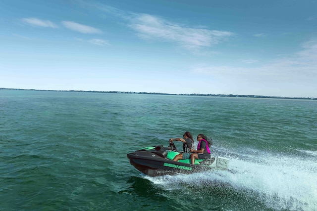 Two people riding a Sea-Doo GTI SE personal watercraft