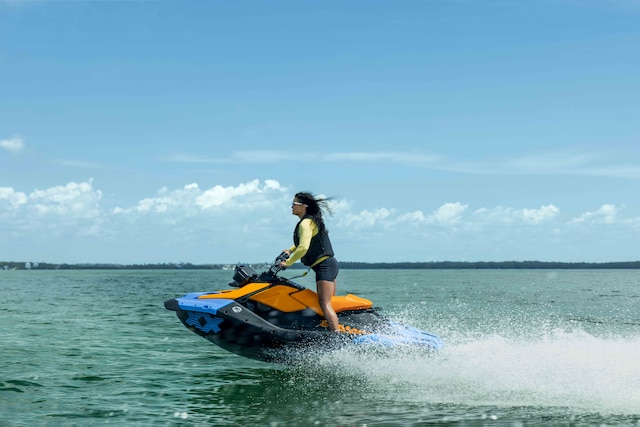 Woman casually riding standing up on a Sea-Doo Spark Trixx PWC
