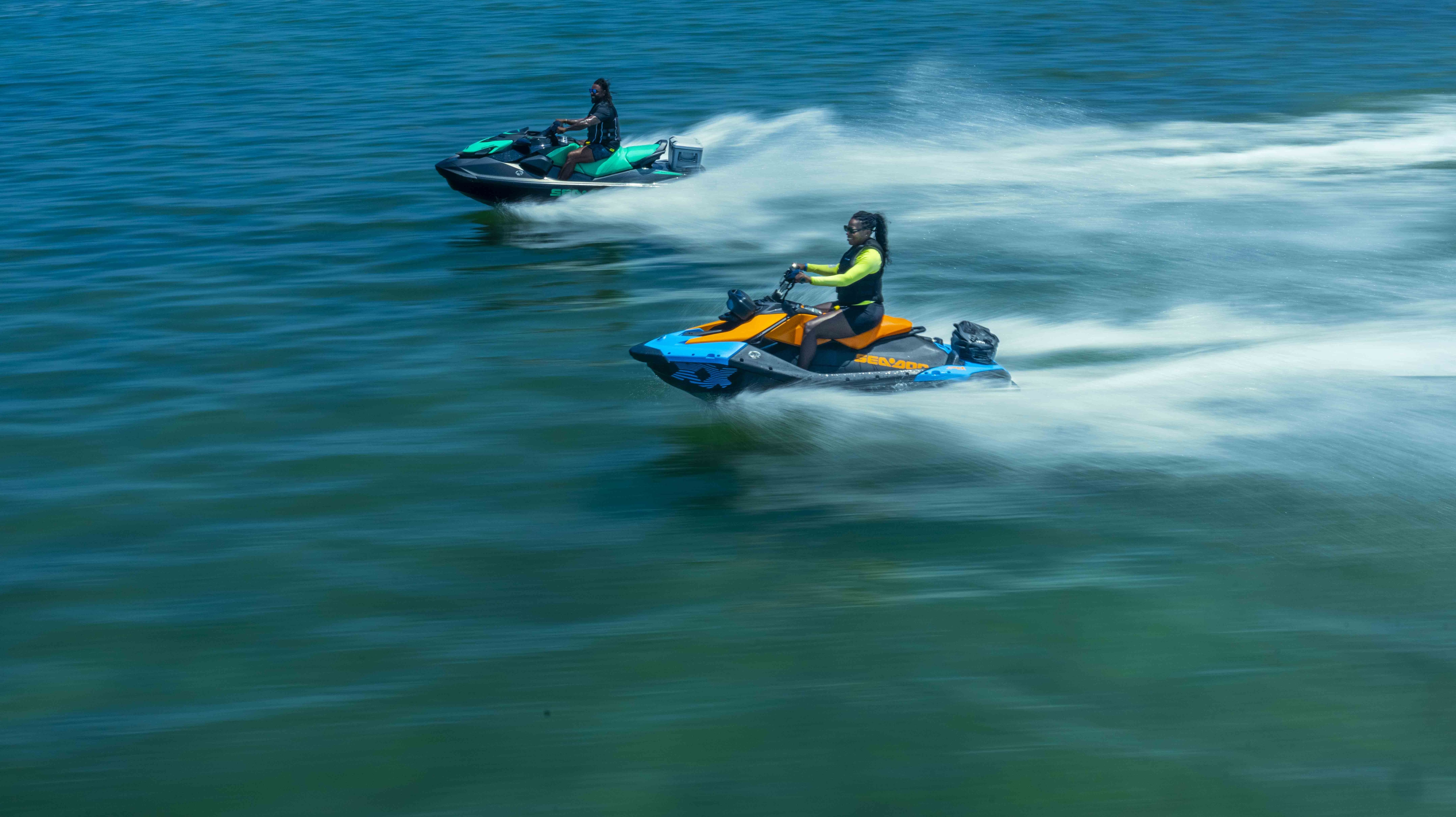 2 riders going at high speed on their Sea-Doo personal watercrafts