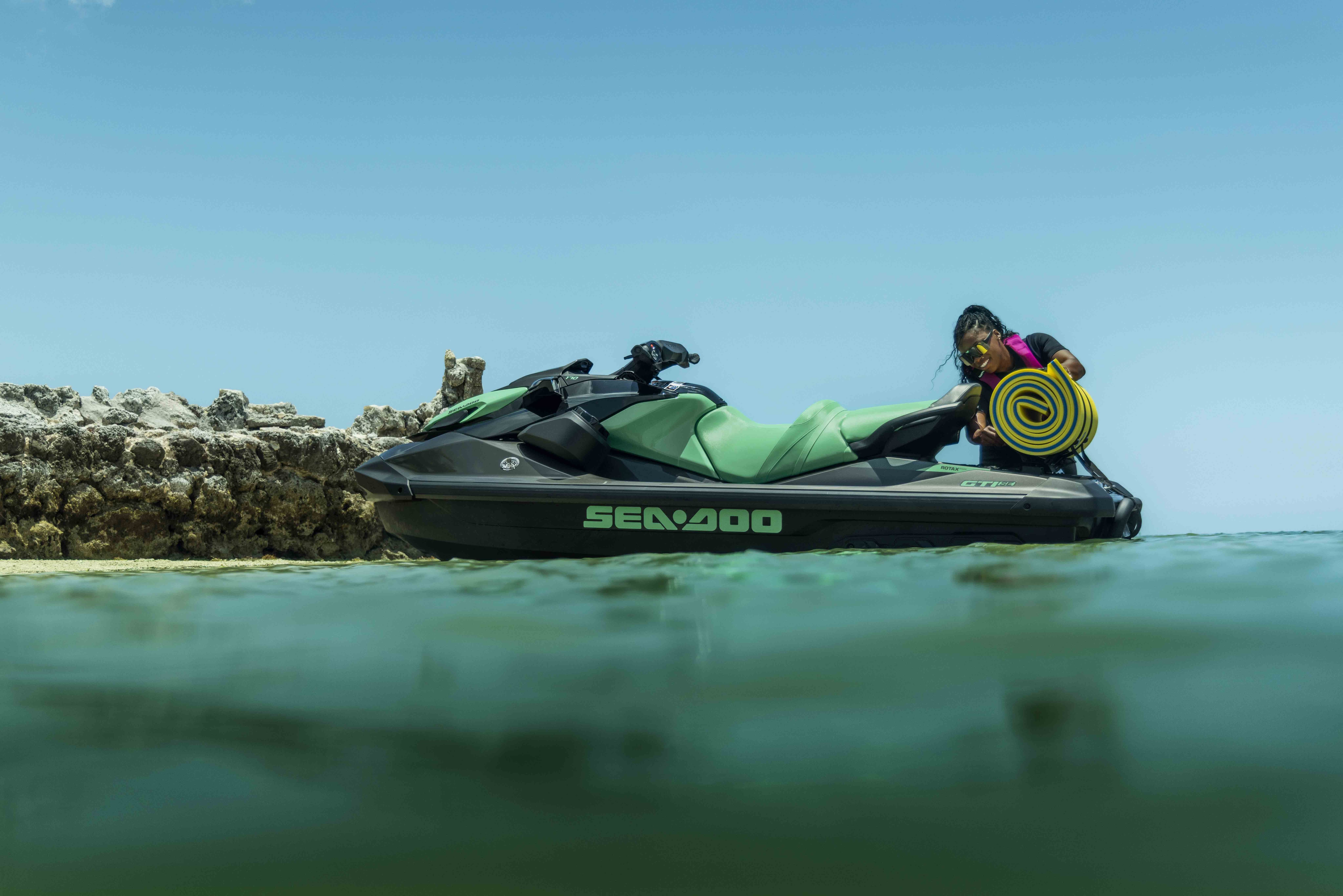 A Woman loading up a Sea-Doo GTI SE