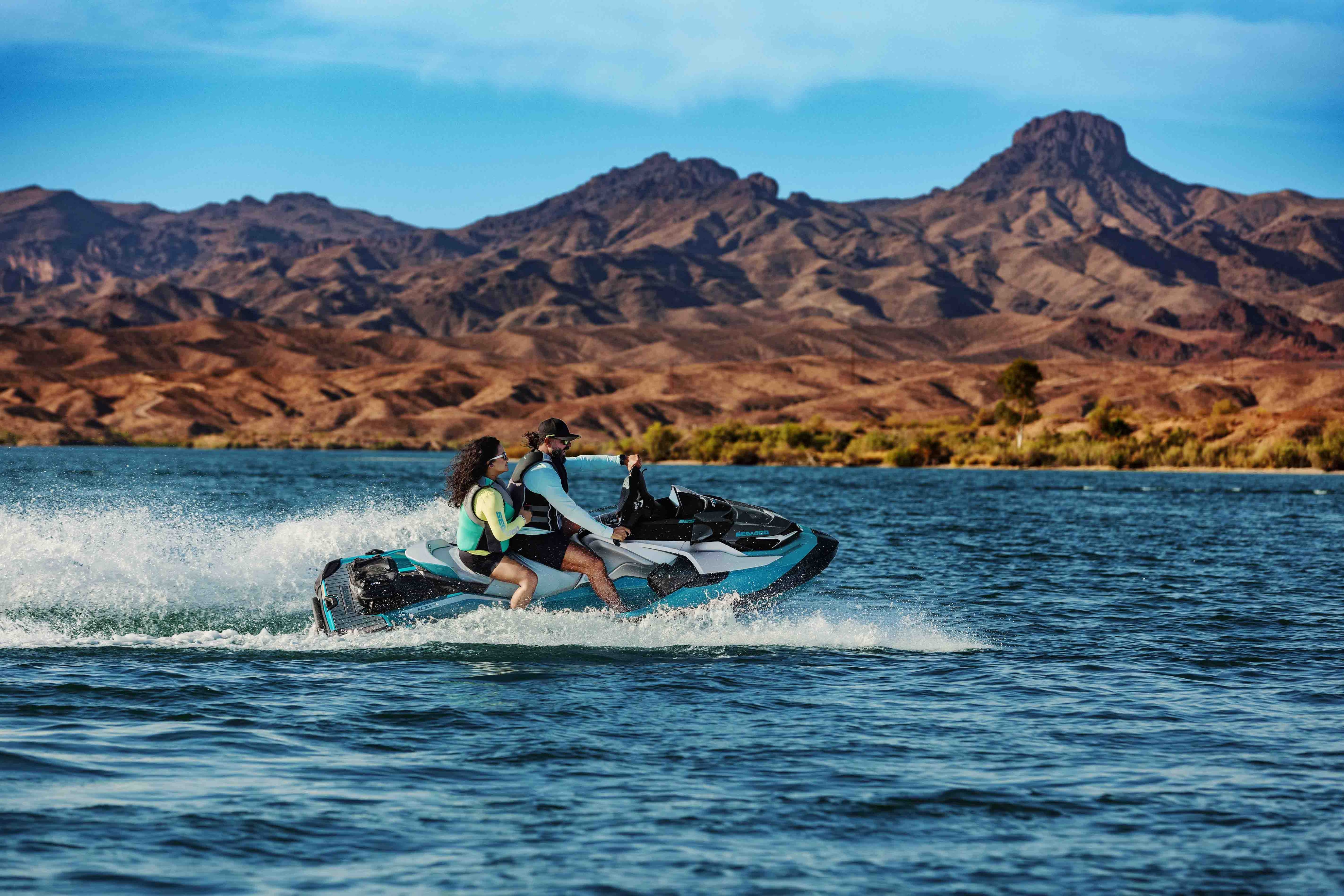 Man and woman sitting on a Sea-Doo GTX Limited personal watercraft
