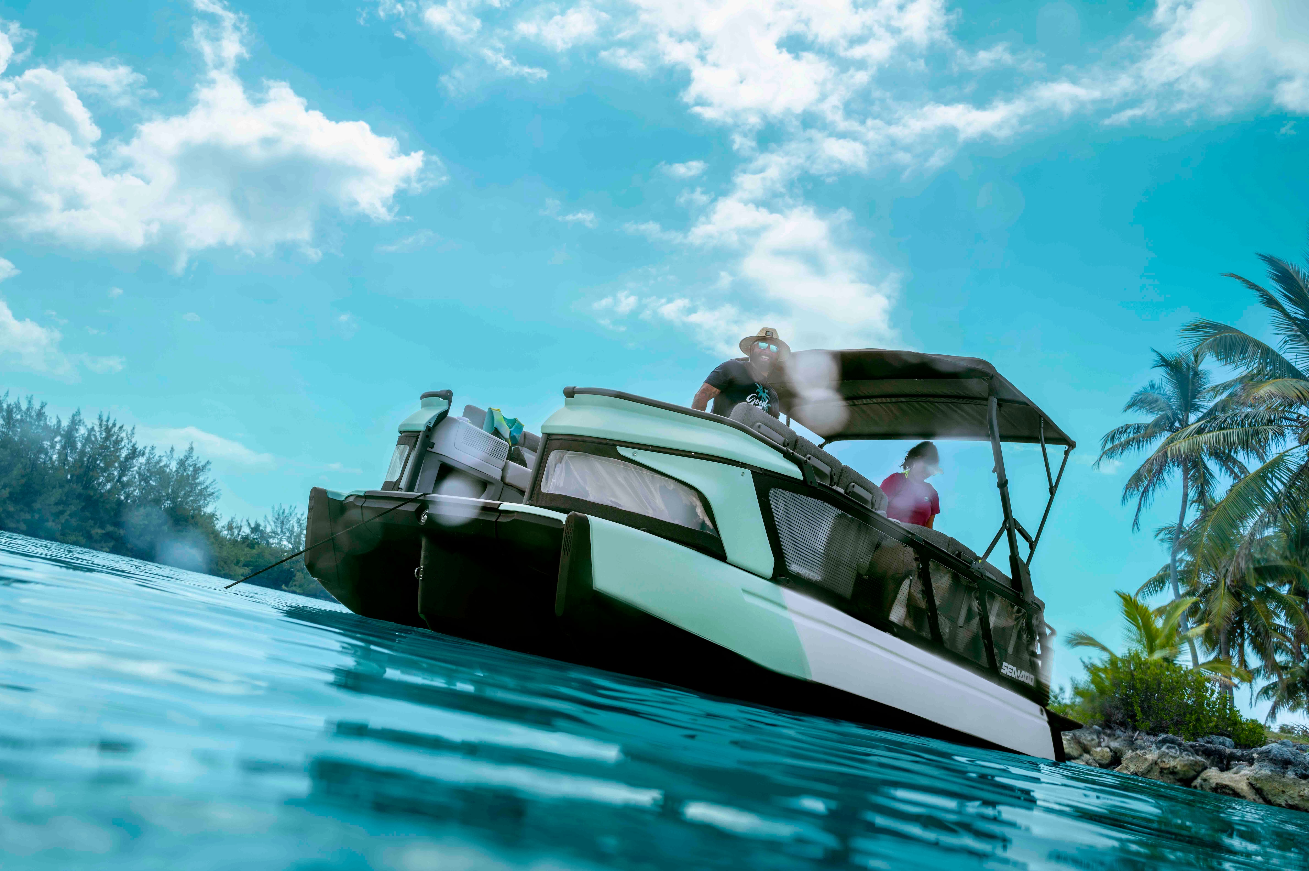 A couple anchoring their Sea-Doo pontoon boat, ready to enjoy a beautiful day.