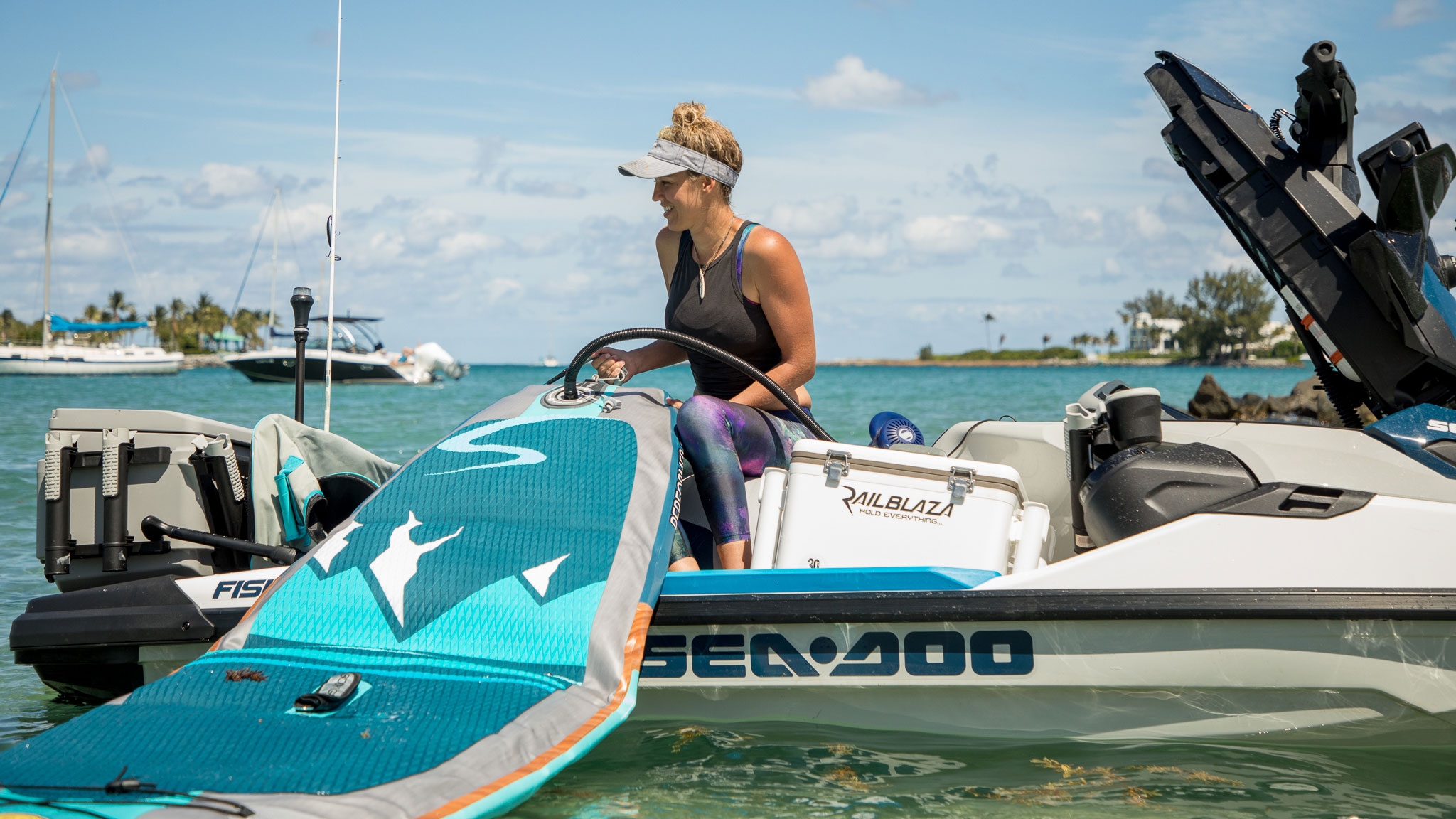 Bri Andrassy inflating her paddle on a Sea-Doo FISHPRO