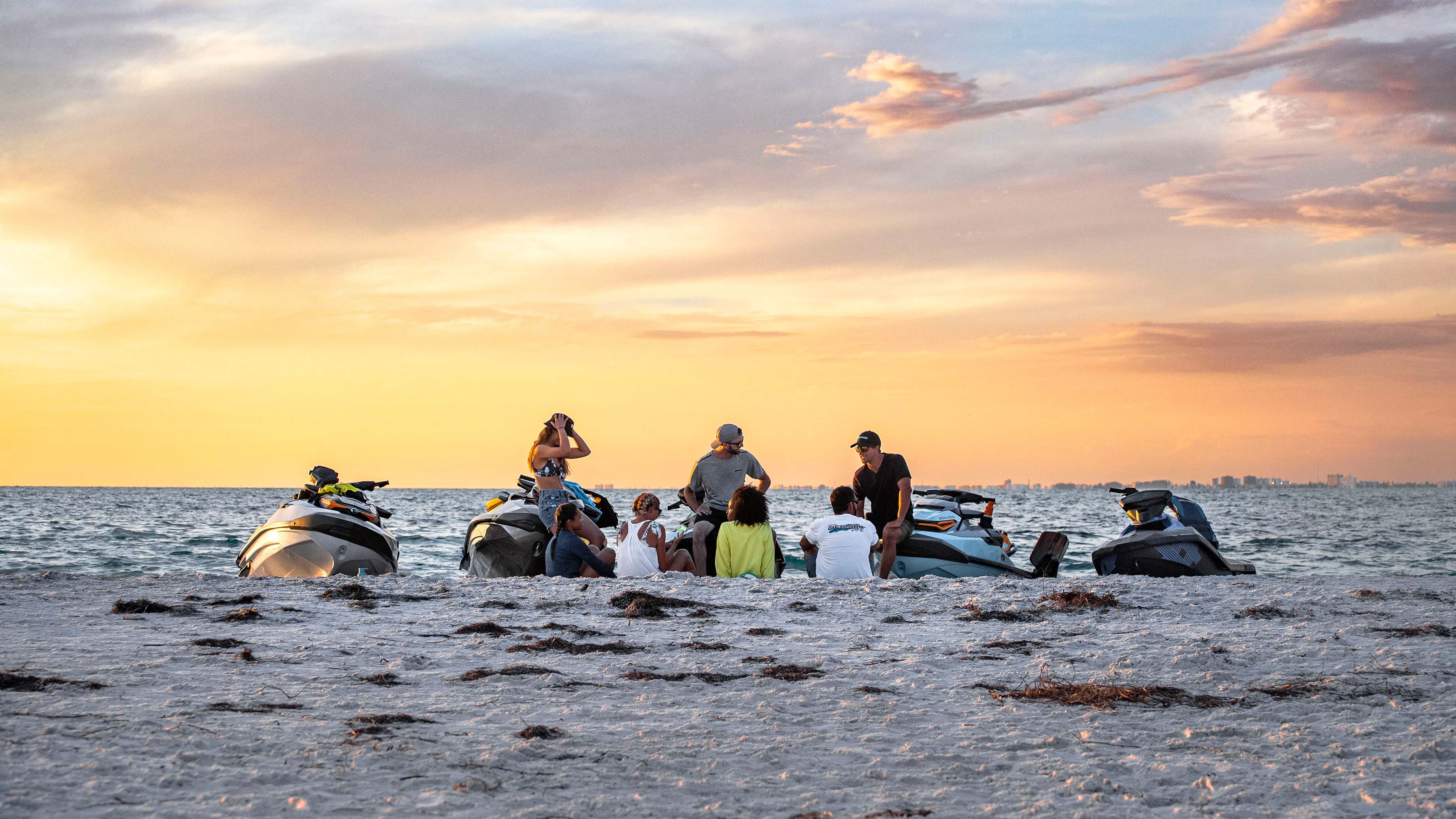 Group of friends on a beach with Sea-Doo watercrafts