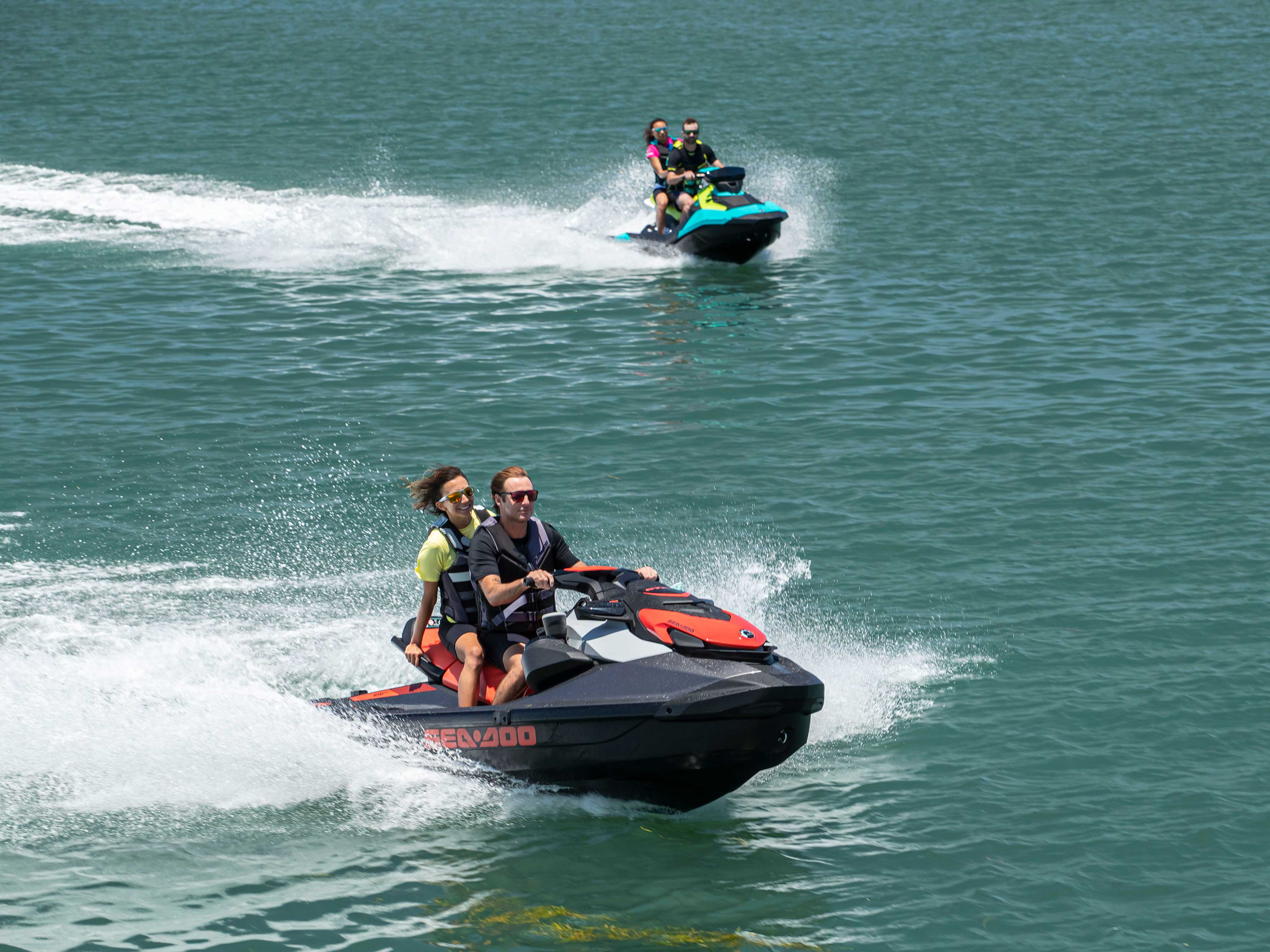 Two couples riding on Sea-Doo SPARK and GTI SE