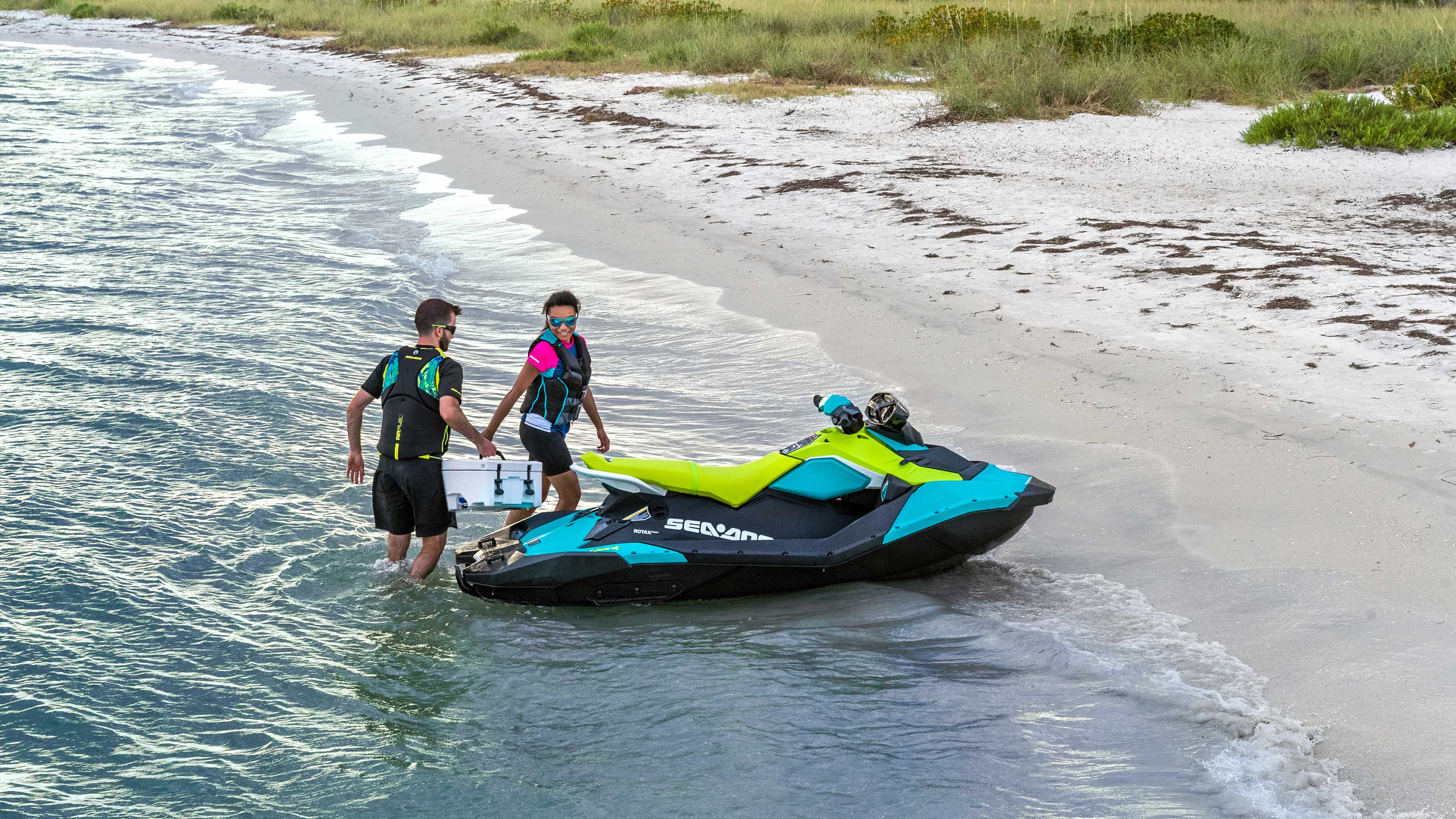 Couple arriving on the beach with their Sea-Doo