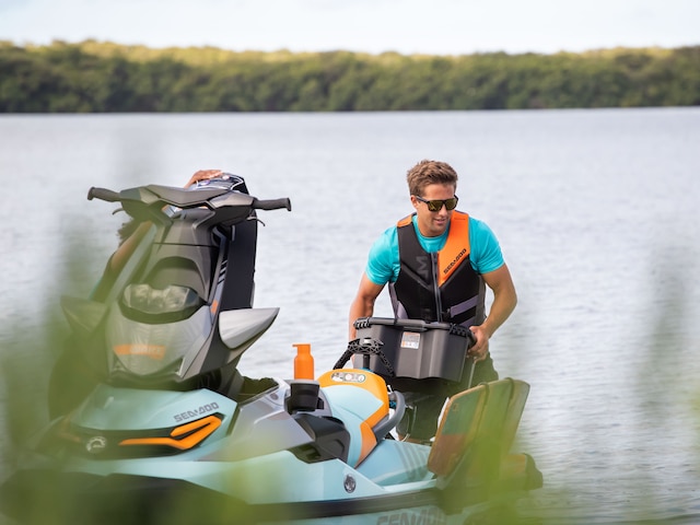 Man grabbing the LinQ 30 L Box from his Sea-Doo WAKE PRO