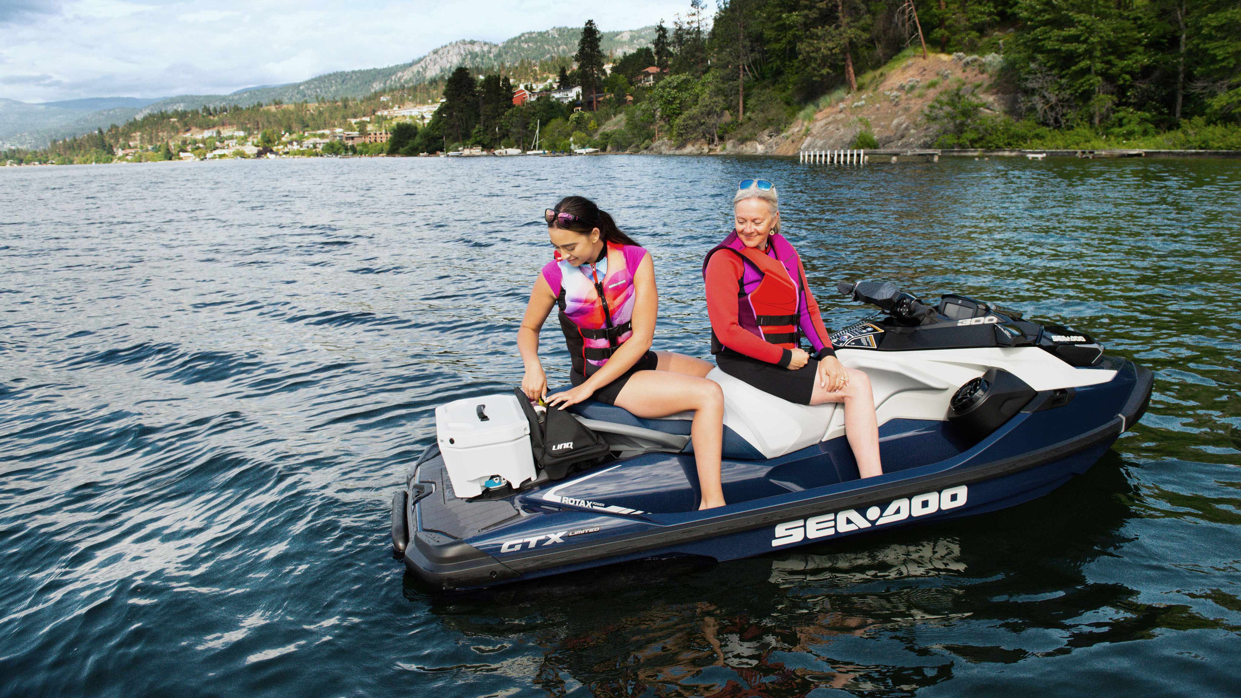 Woman taking out something from a LinQ bag while seating on a Sea-Doo GTX Limited