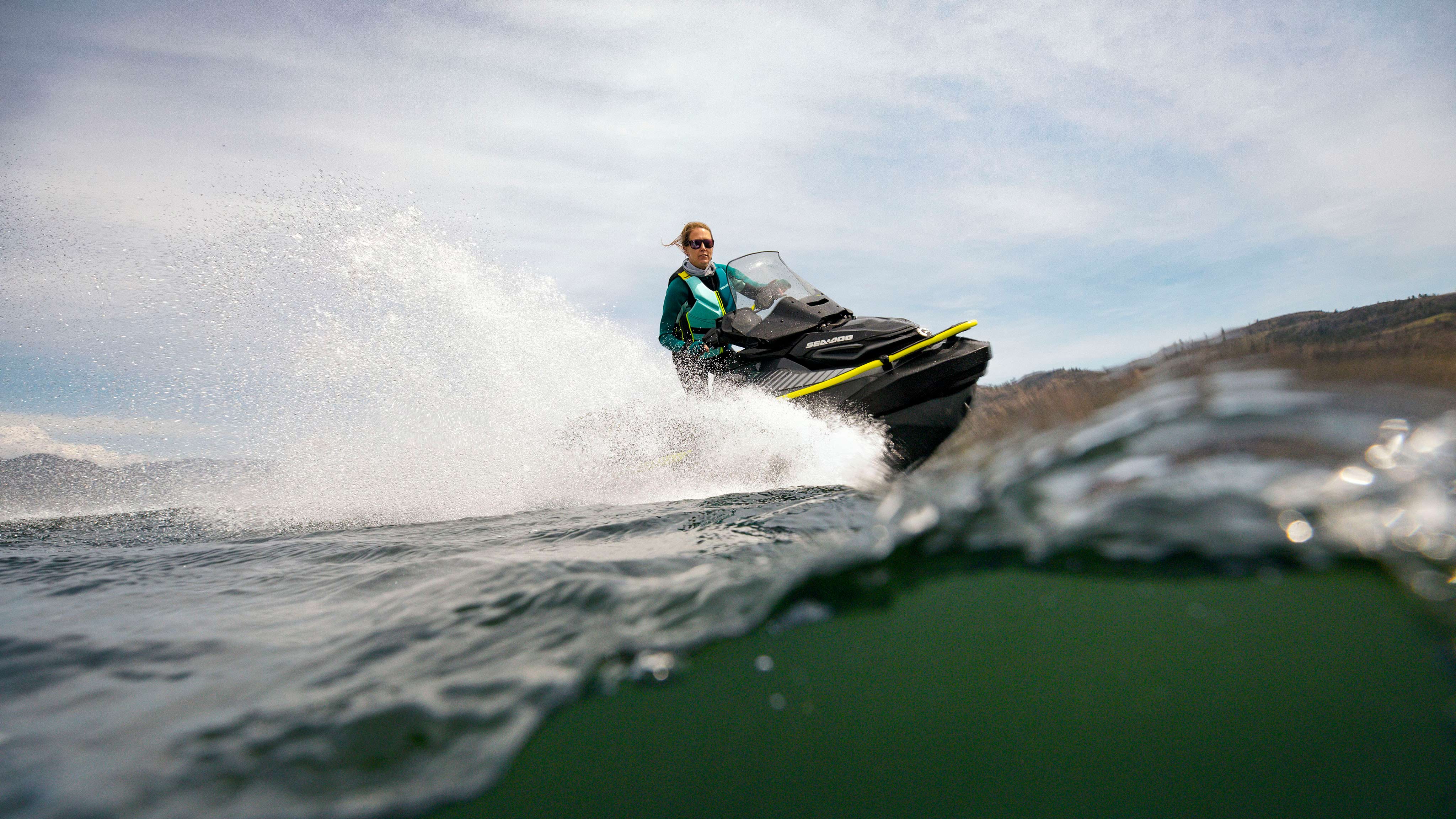 Woman riding the Sea-Doo Explorer Pro 170 with the front bumper