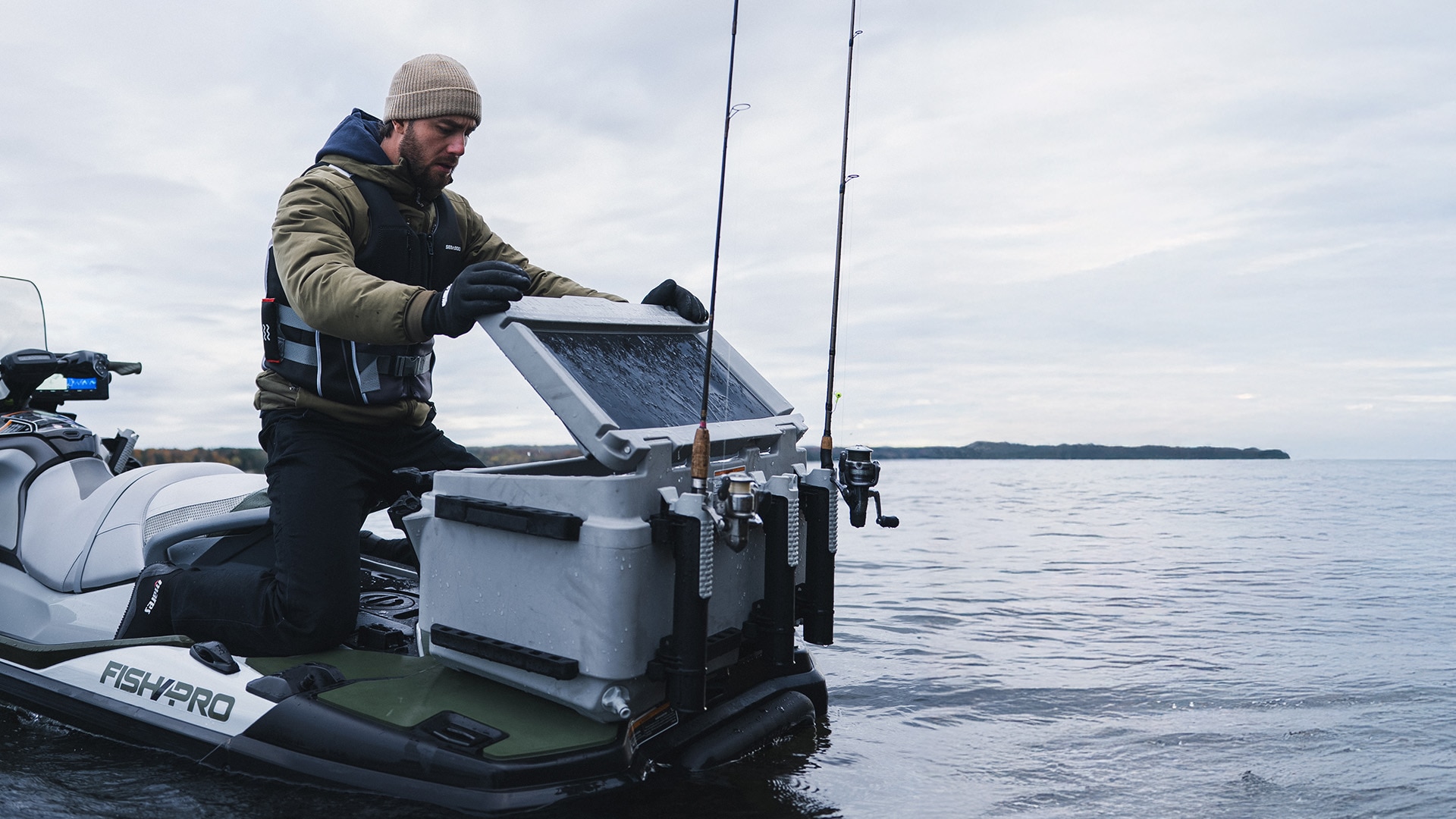 A fisherman opening a cooler located in the back of his Sea-Doo FishPro personal watercraft