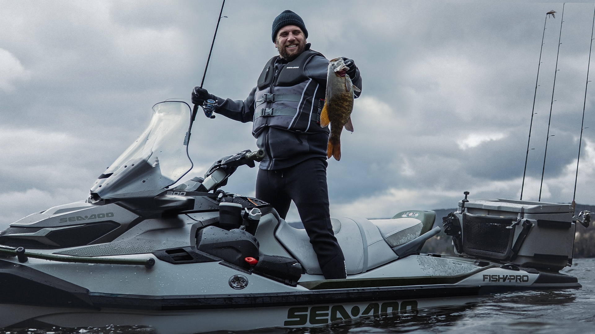 A fisherman who has just caught a fish on his Sea-Doo FishPro personal watercraft