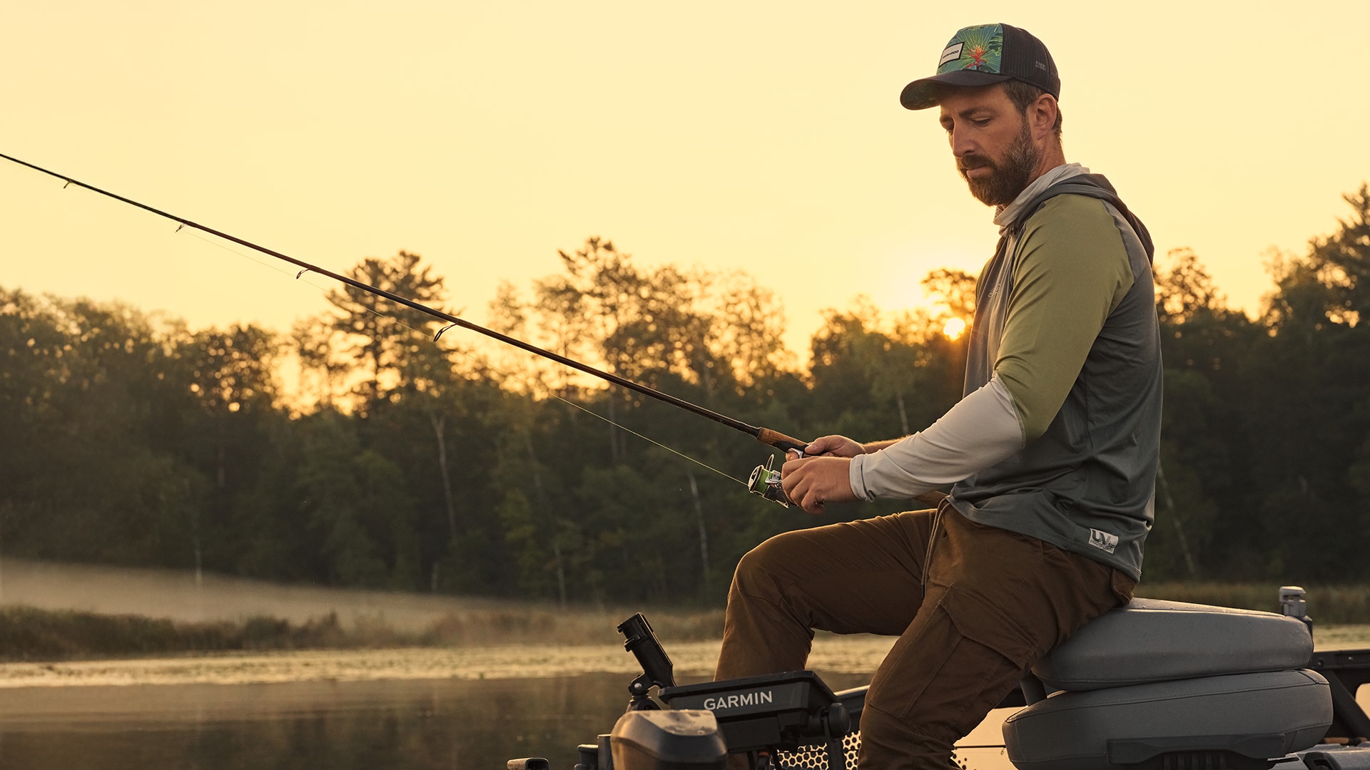 A fisherman who has just caught a fish on his Sea-Doo FishPro personal watercraft