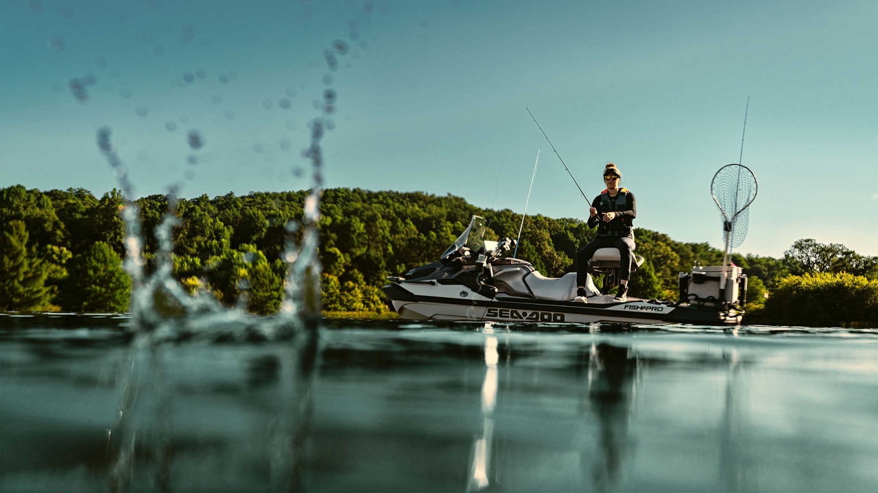 A woman fishing from a 2025 Sea-Doo FishPro Apex personal watercraft.