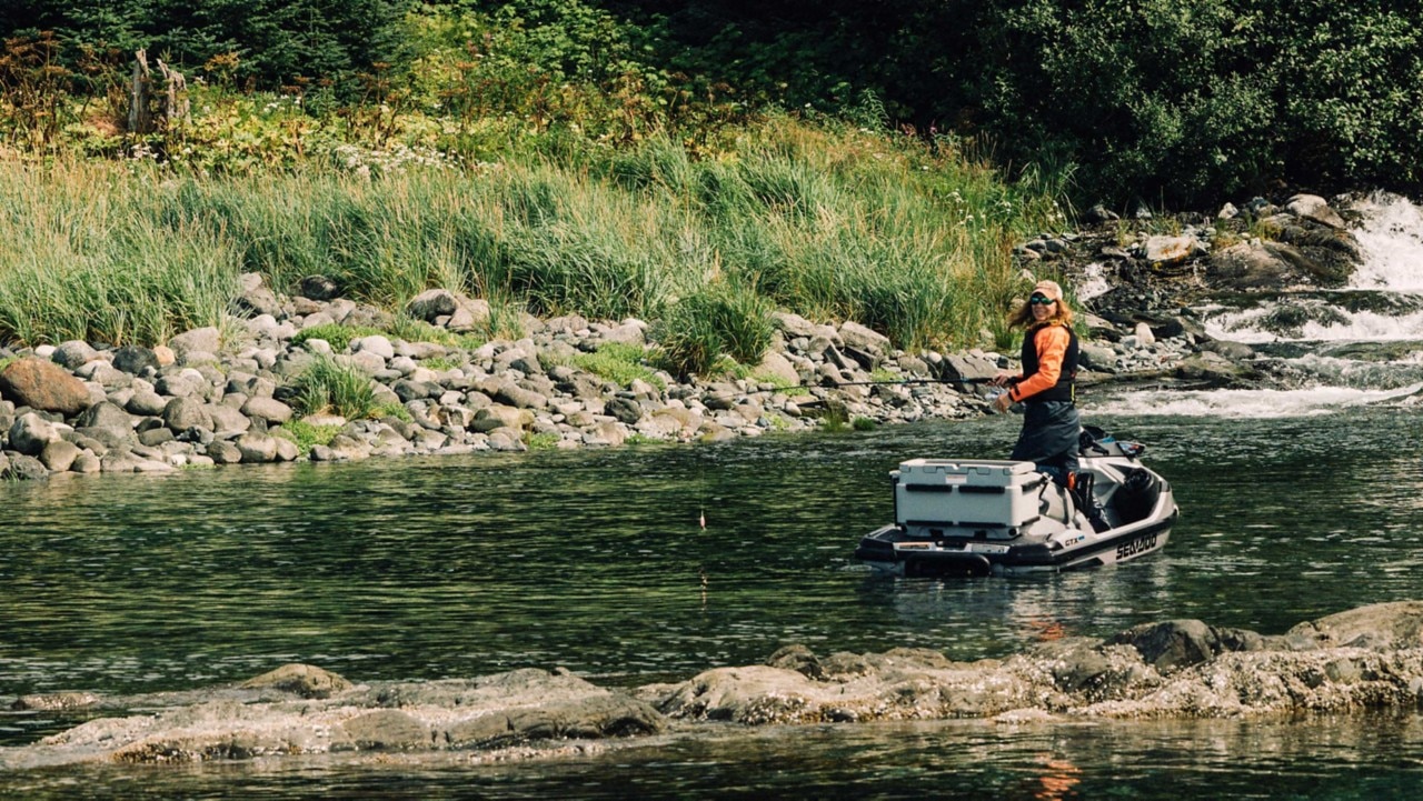 Michelle Oakley fishing and smiling on Sea-Doo